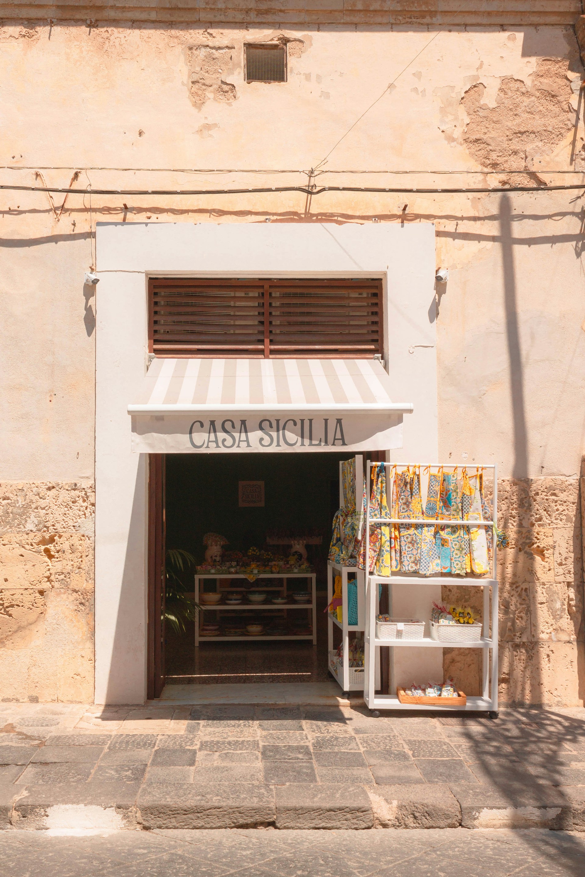 A store front with a white awning over it