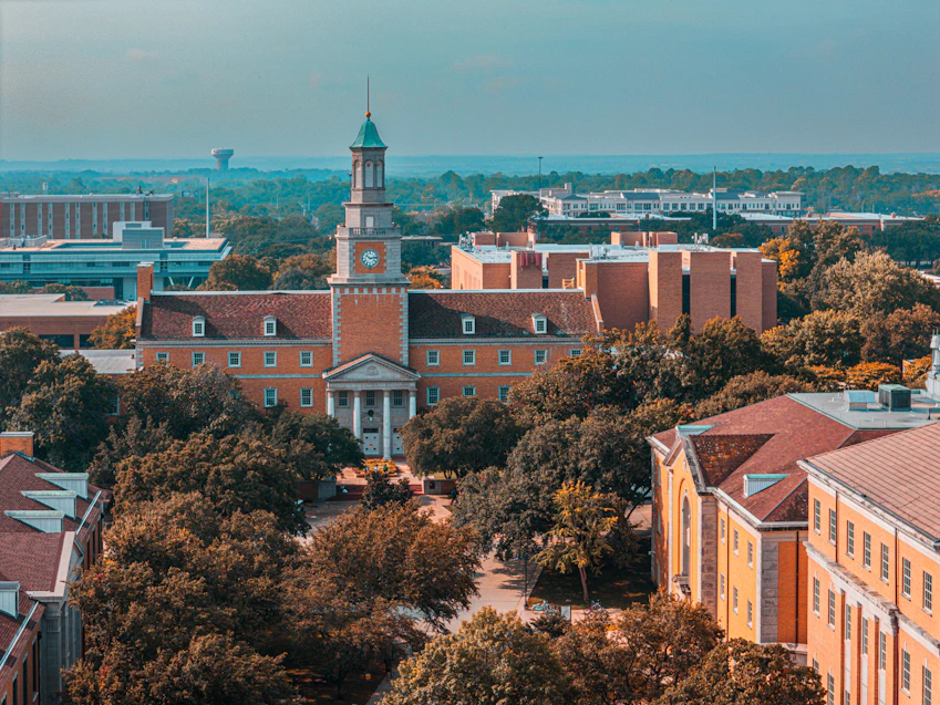 An aerial view of a campus with a clock tower