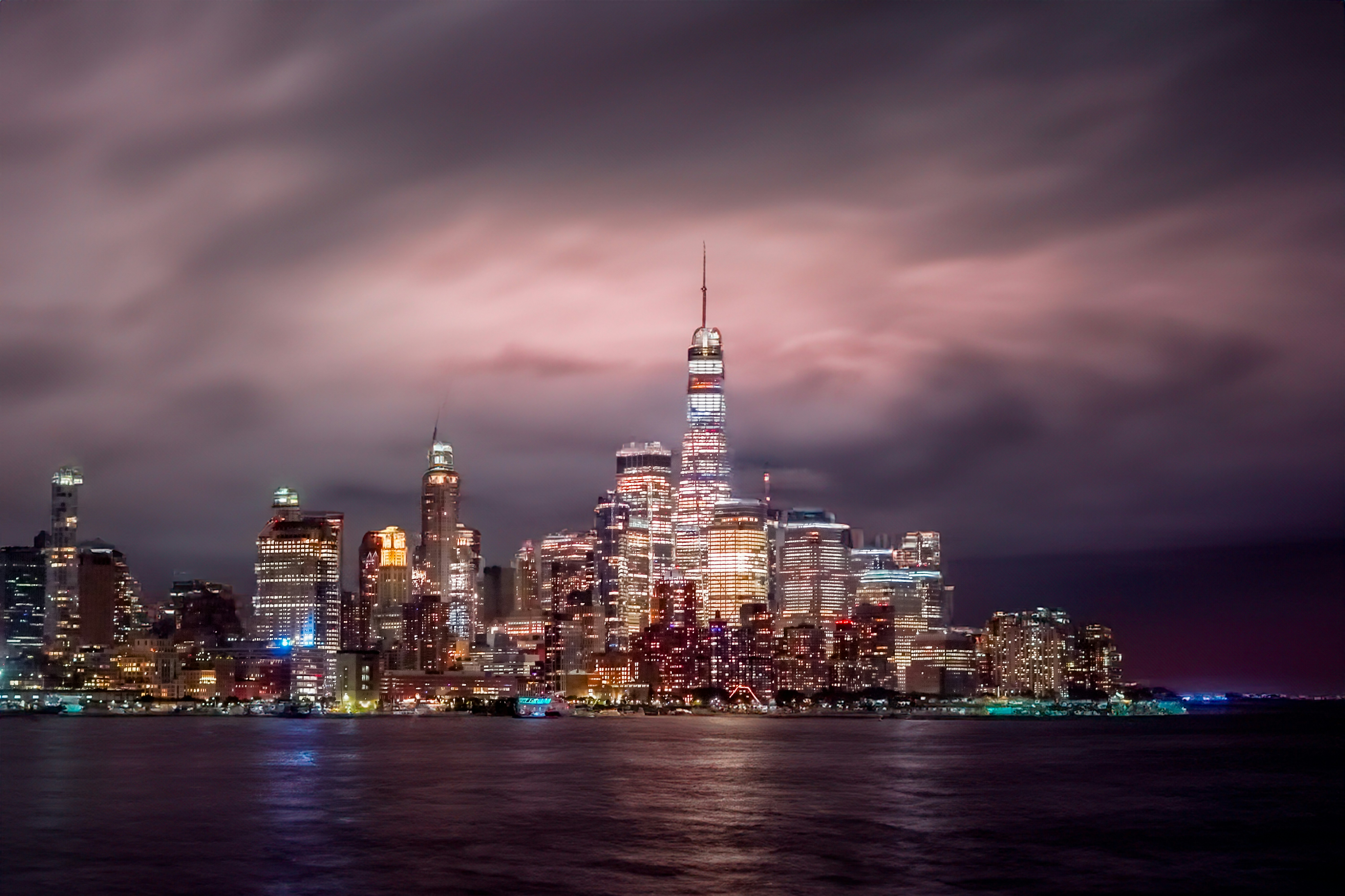 A view of a city at night from the water