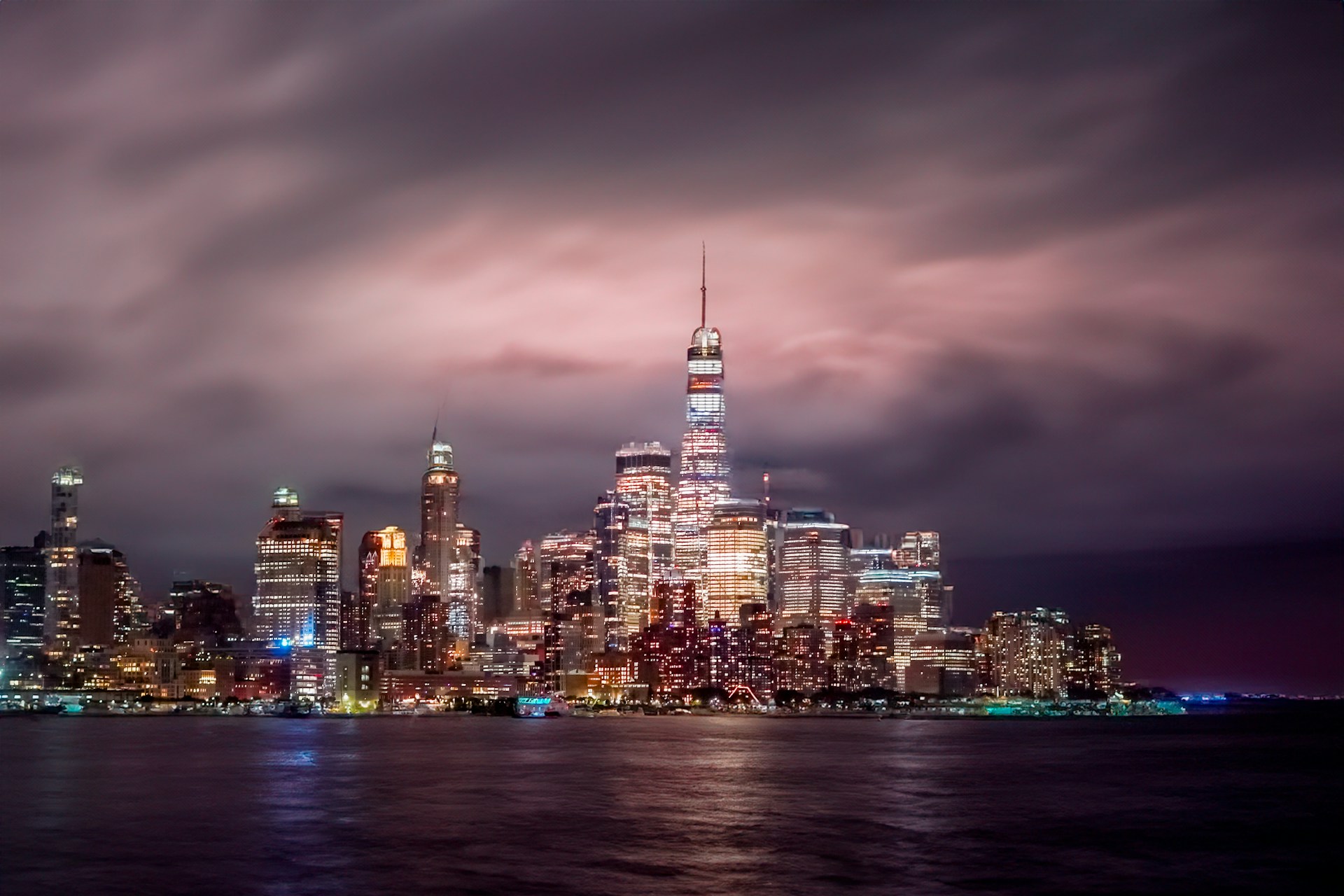 A view of a city at night from the water