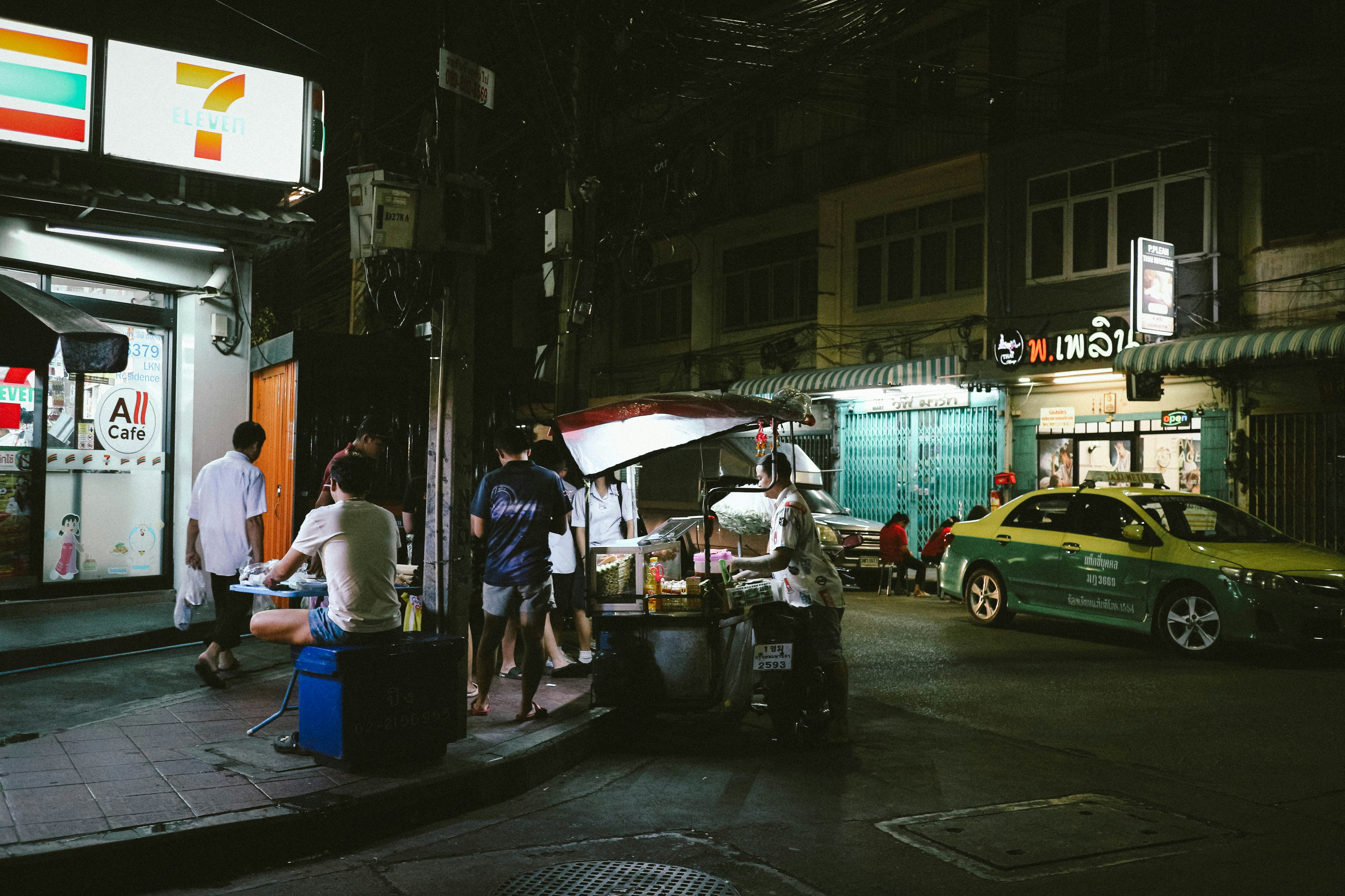 A group of people standing outside of a gas station