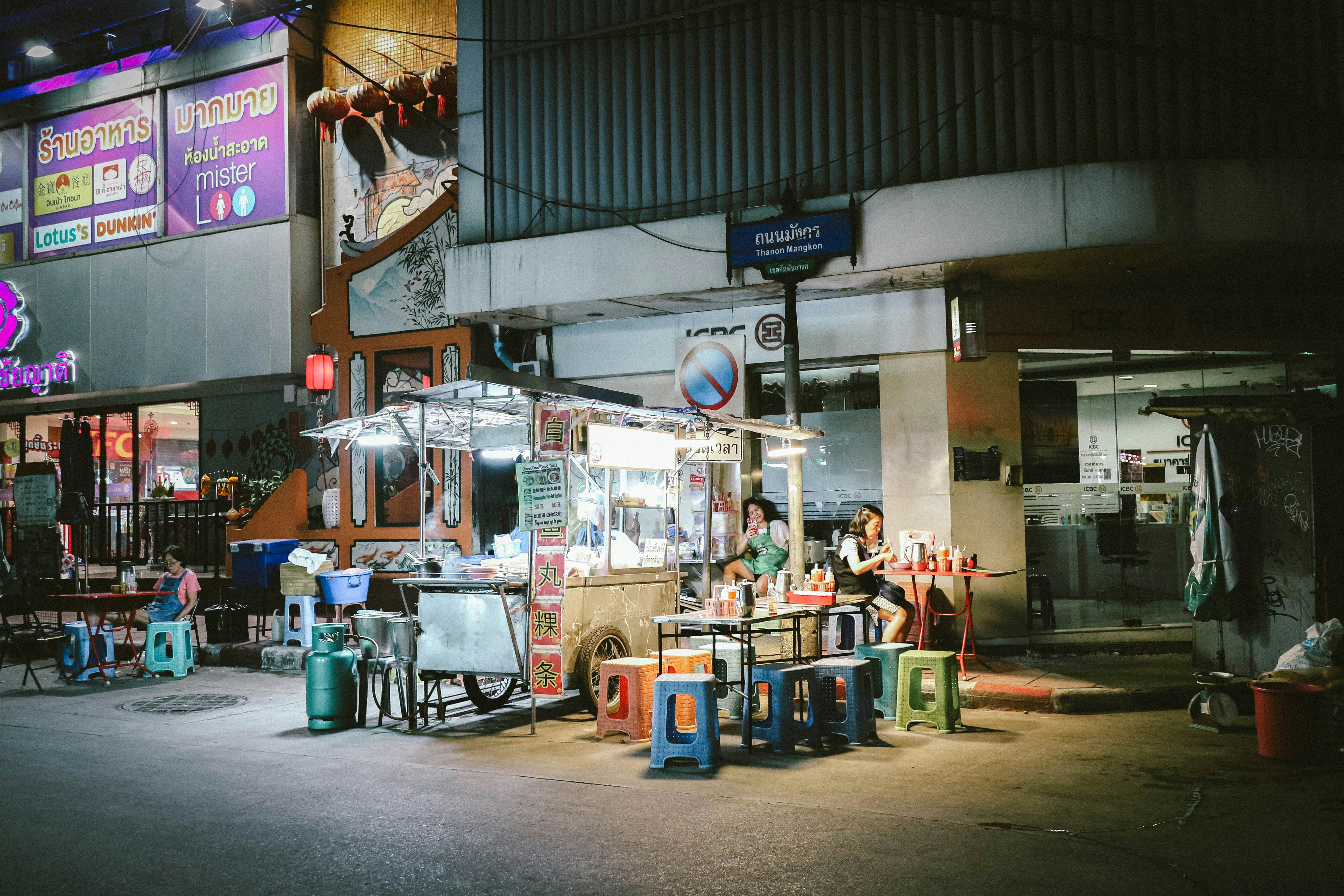A group of people sitting at a table in front of a building