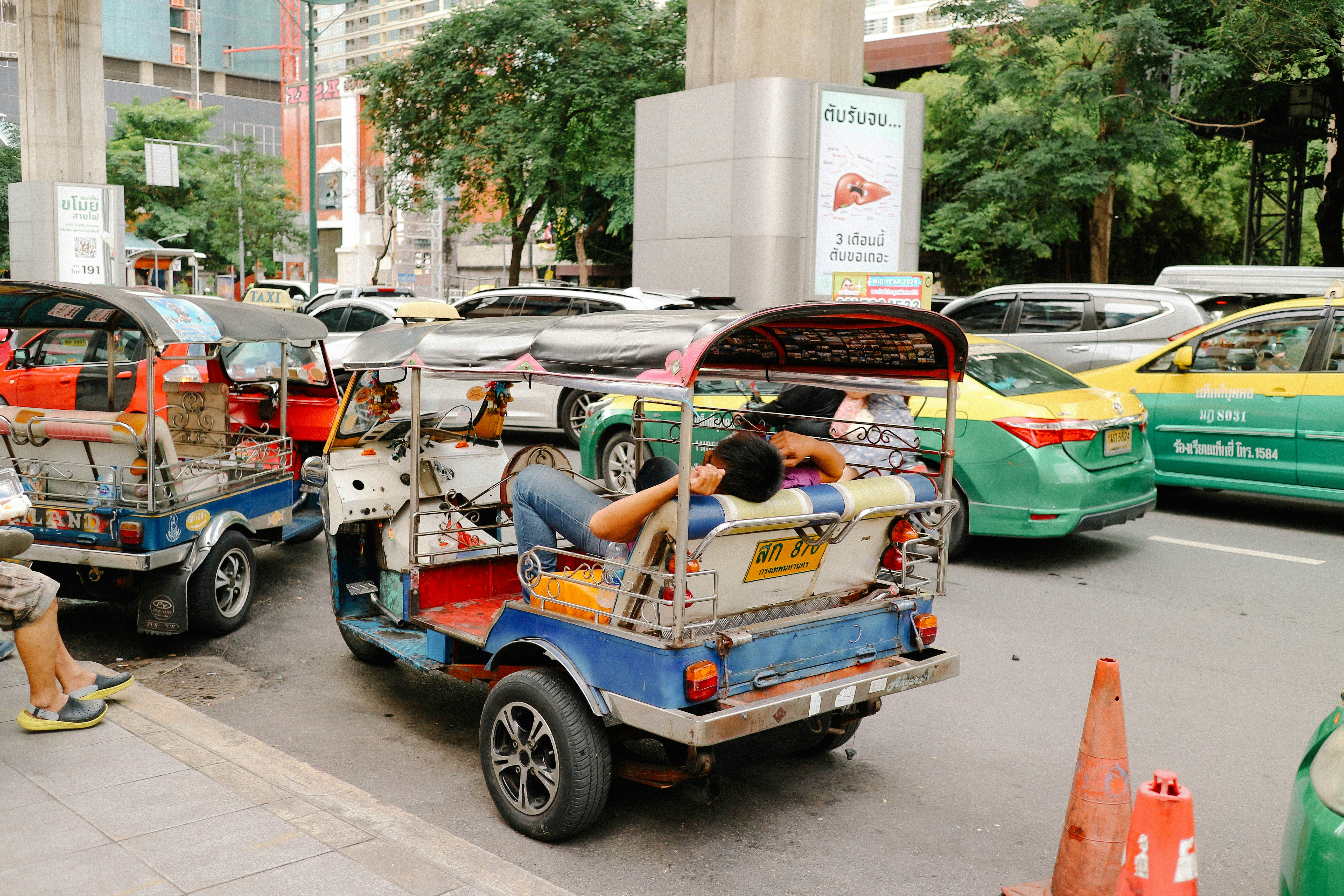 A group of people riding on the back of a truck down a street