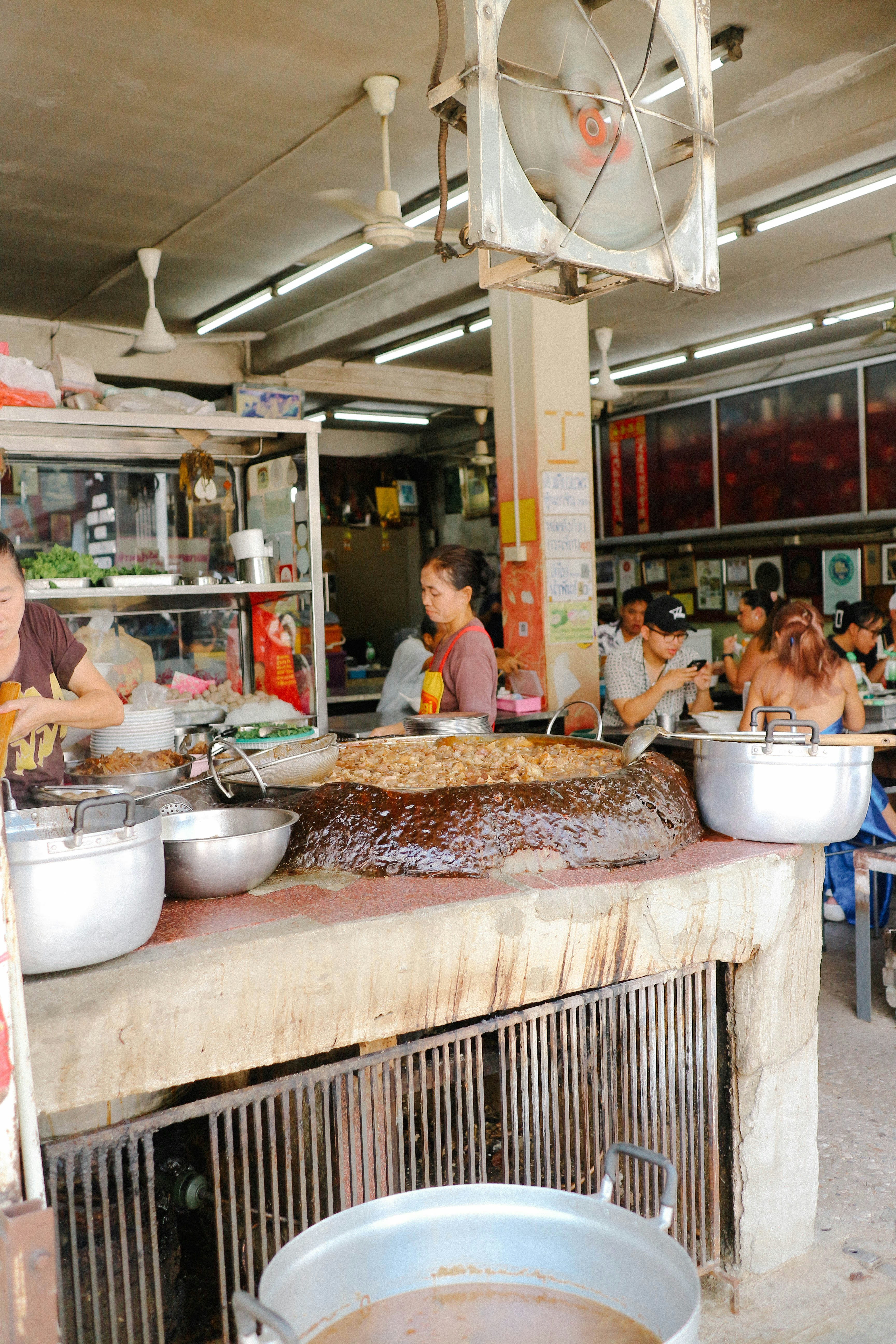 A group of people sitting around a table with food on it