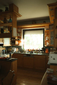 A kitchen filled with lots of wooden cabinets