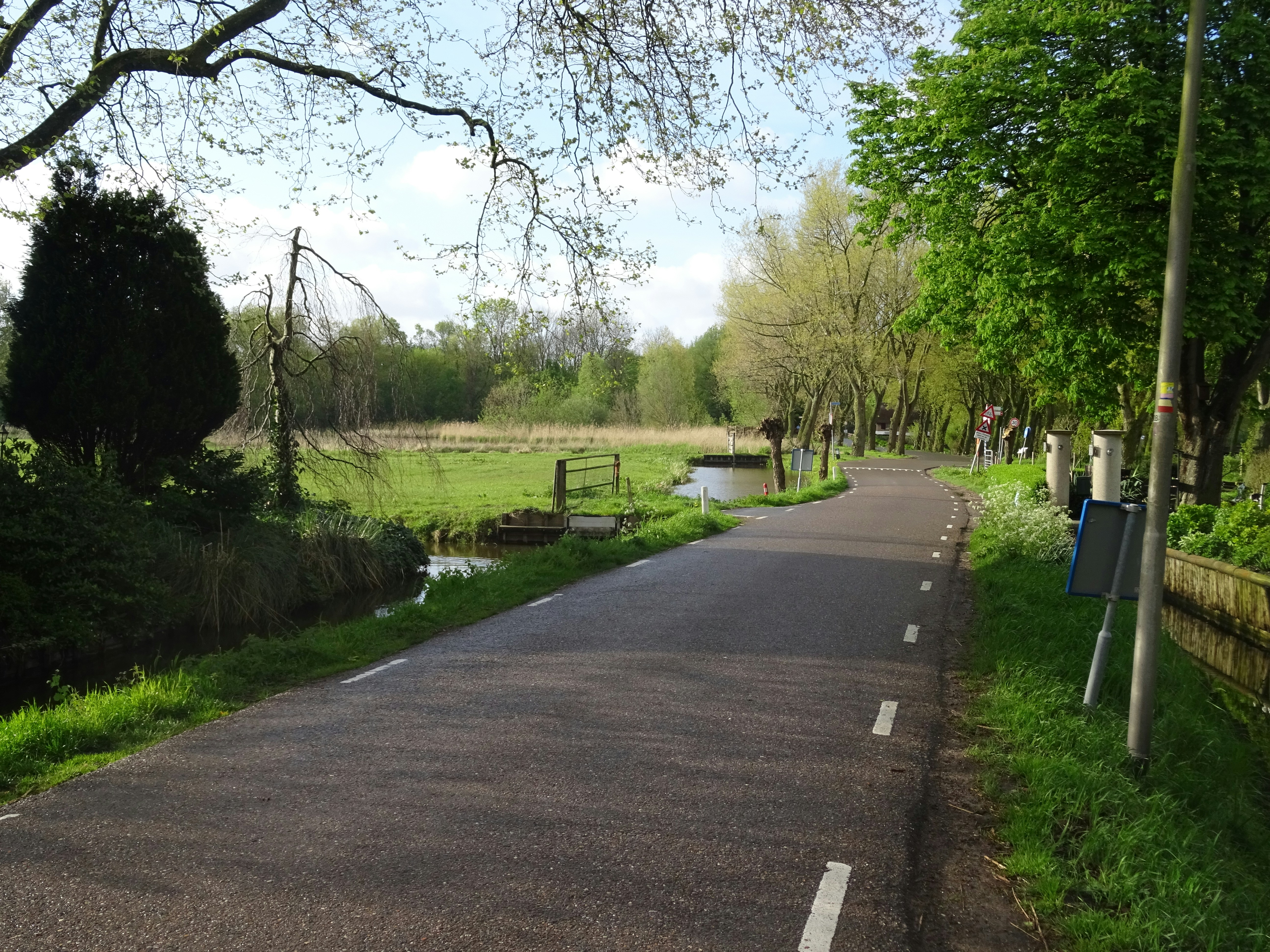 A paved road with a sign on the side of it