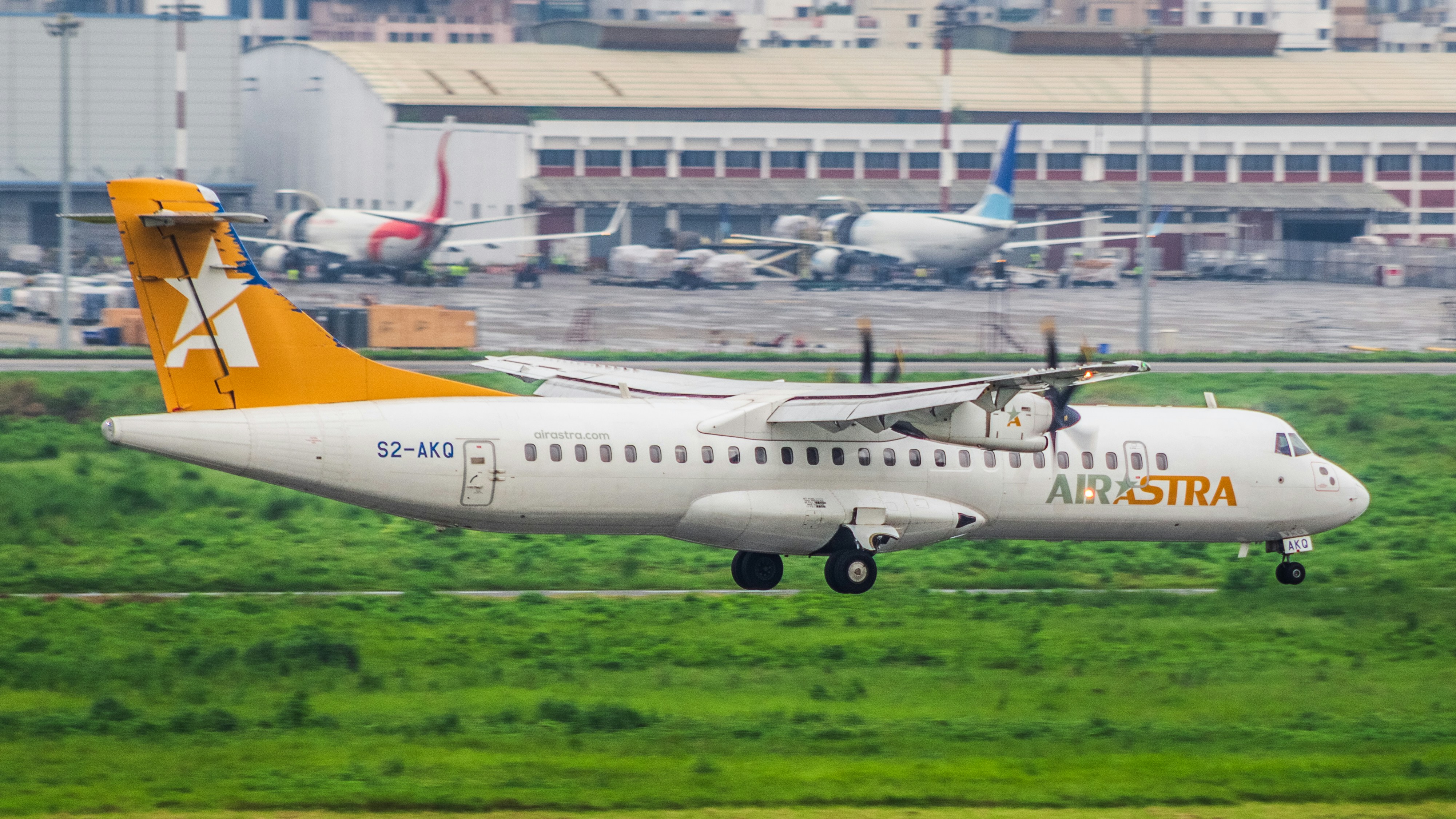 A white and orange airplane is taking off, 