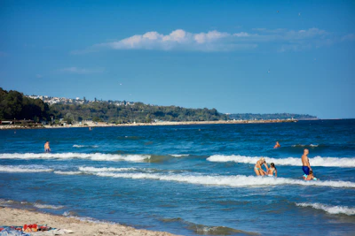 People in the surf on Varna’s city beach, the Sea Garden along the shore