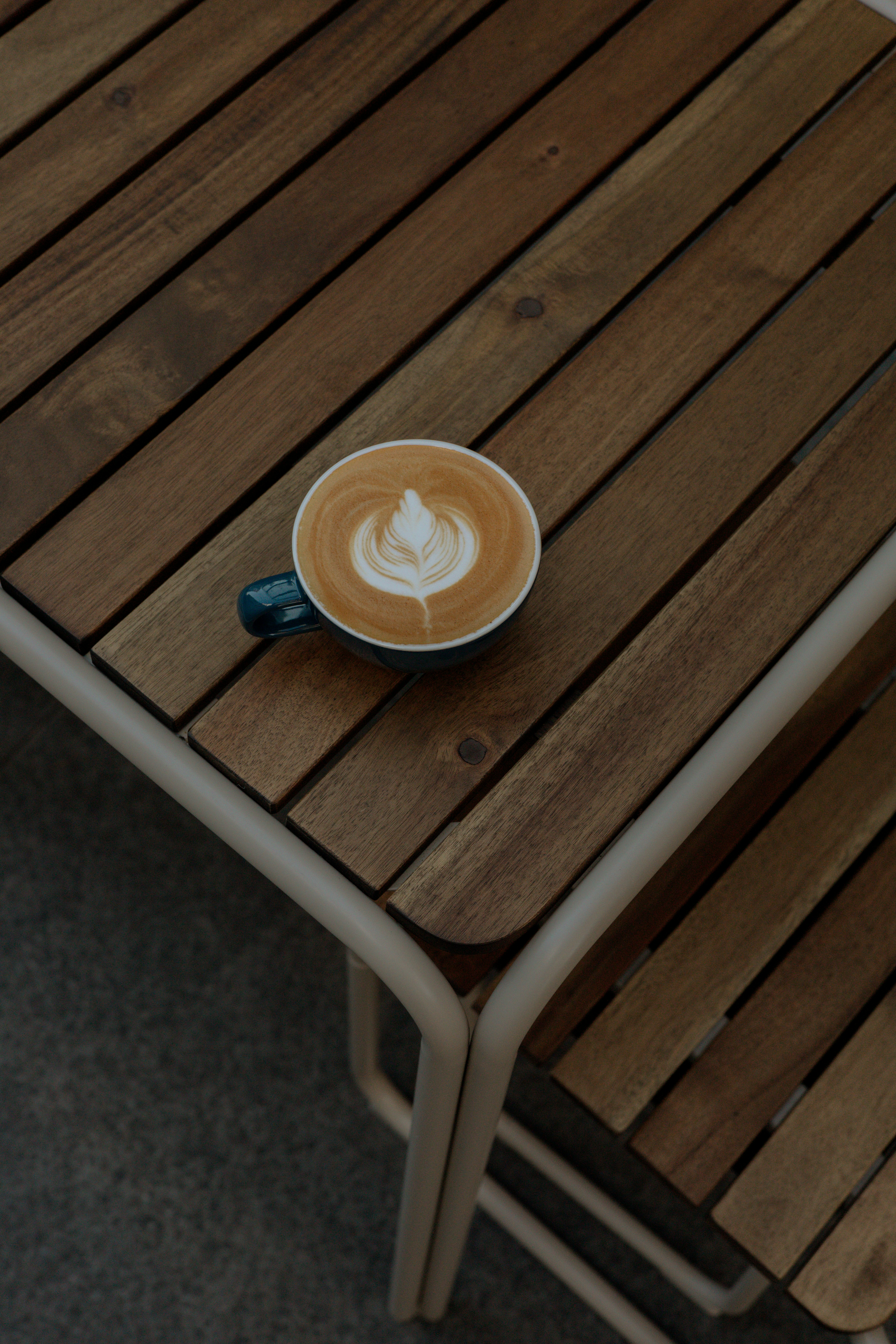 A cup of coffee sitting on top of a wooden table