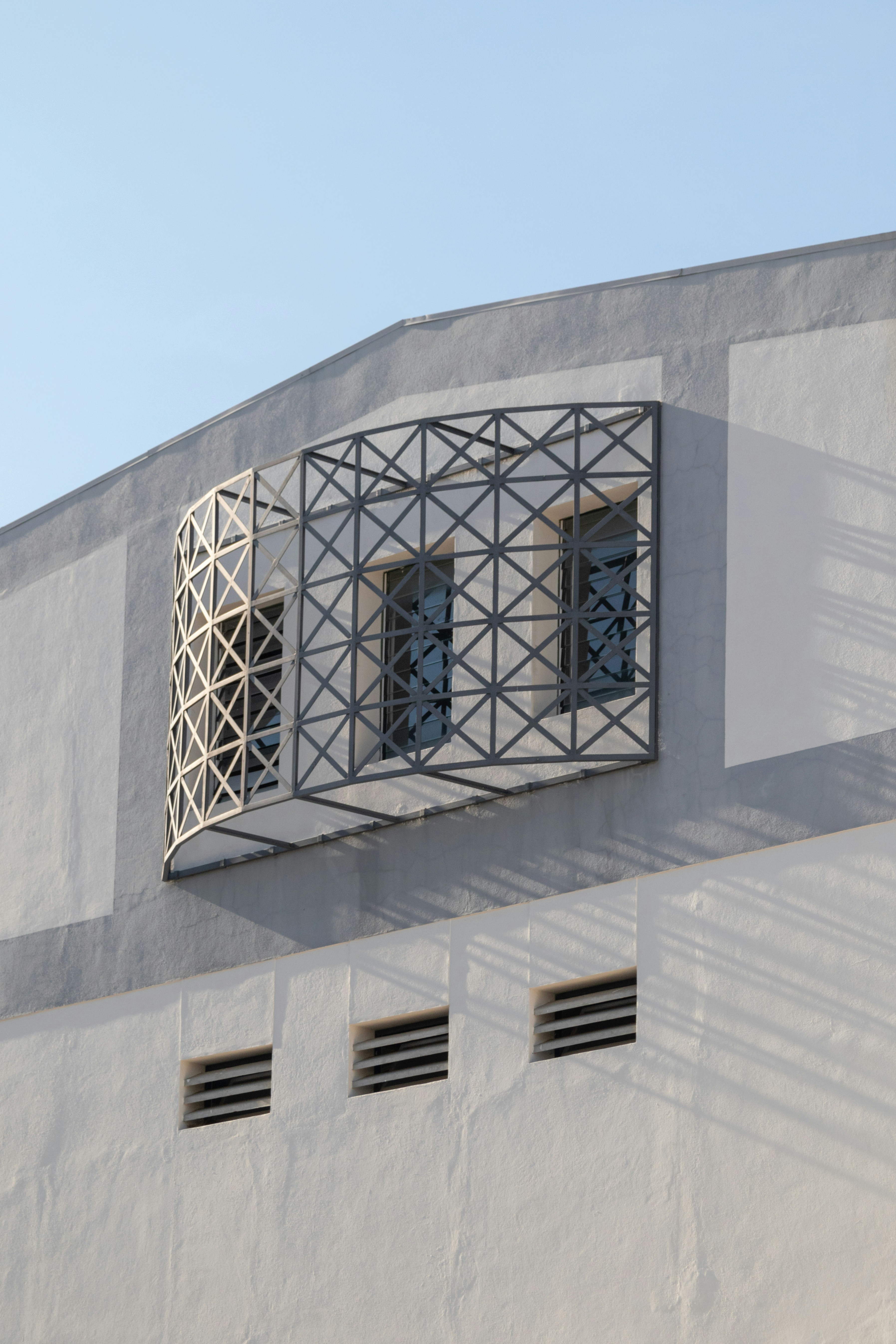 A white building with a window and shutters