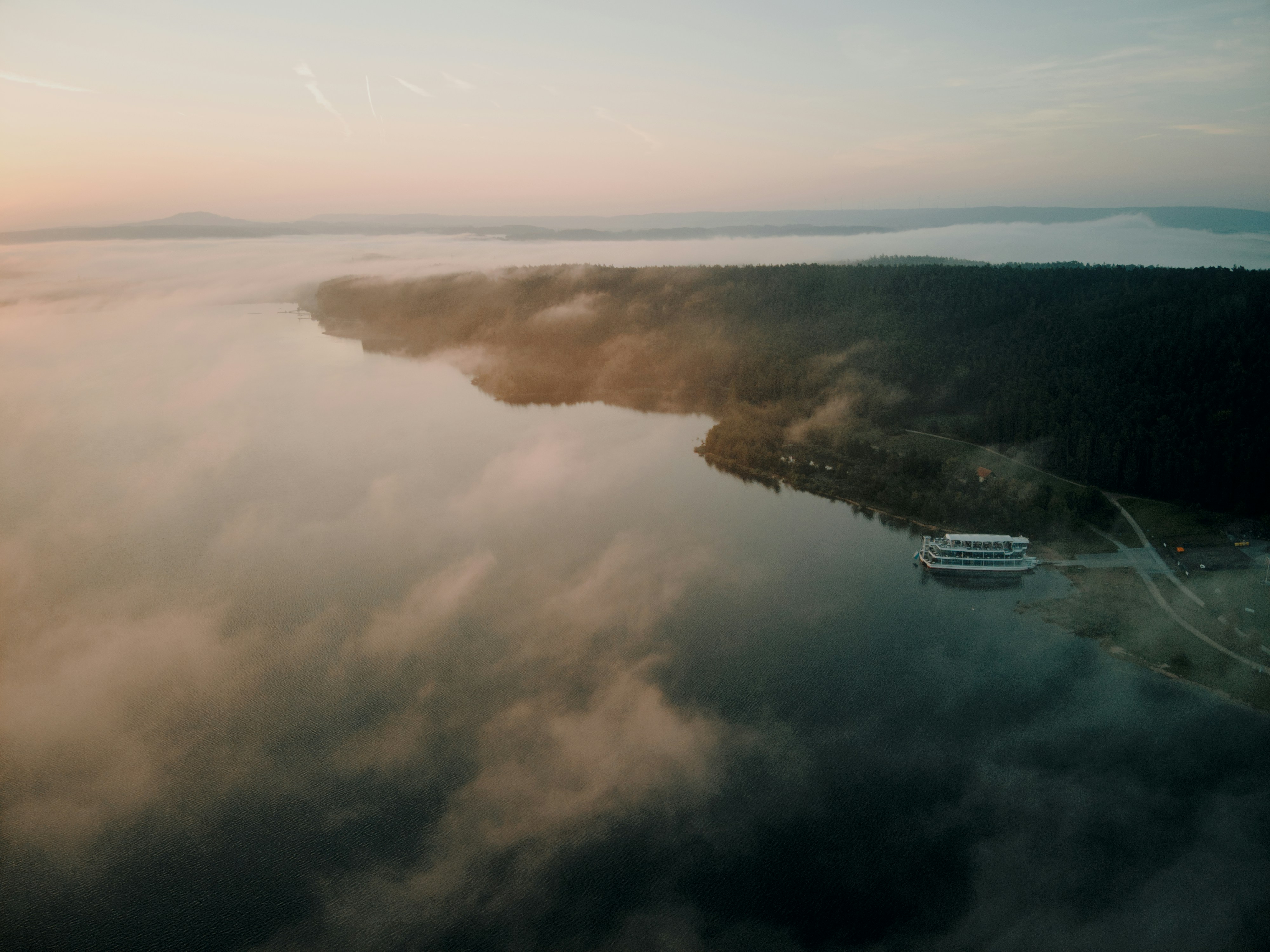 A large body of water surrounded by clouds