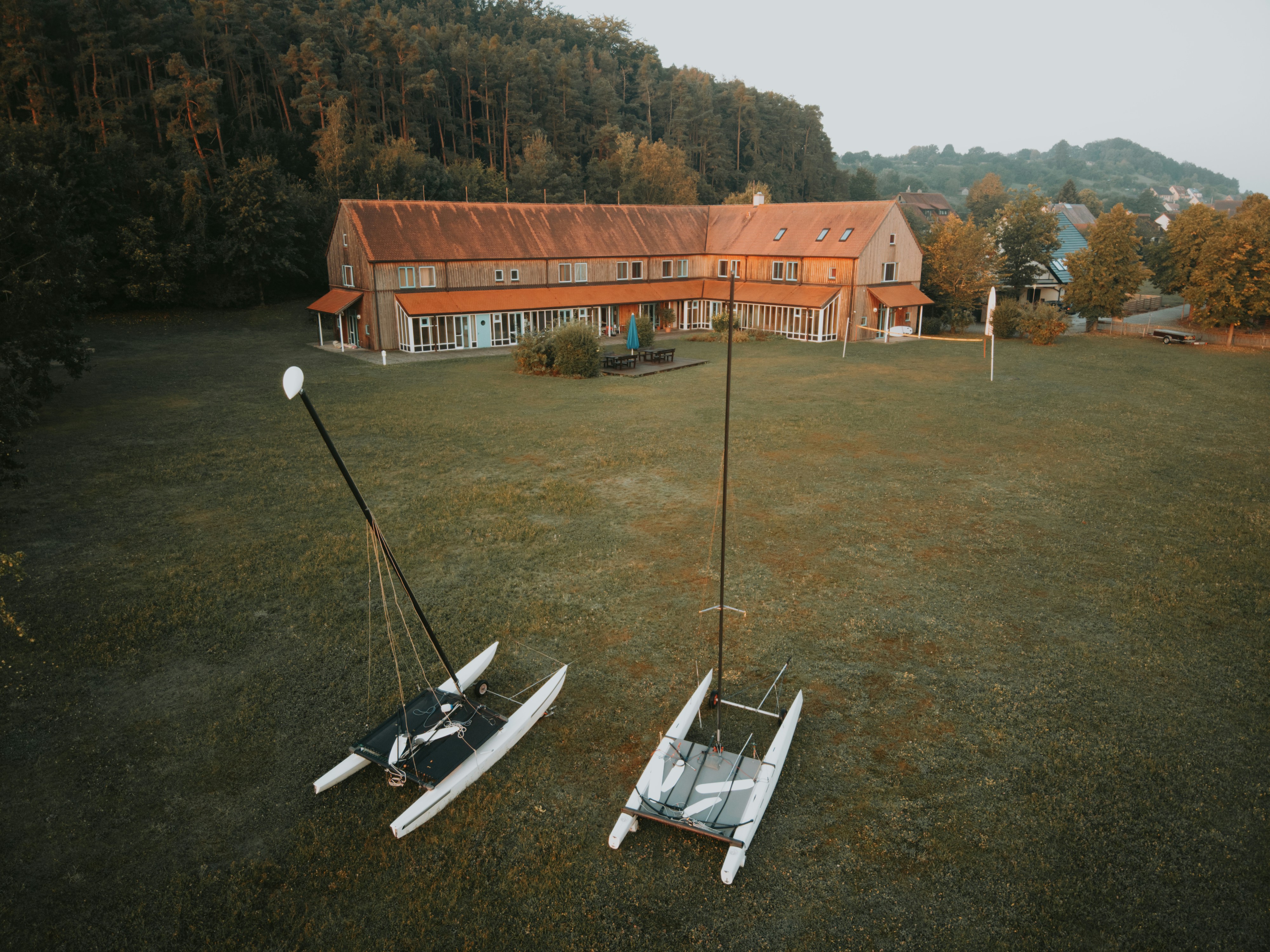 A couple of boats sitting on top of a lush green field