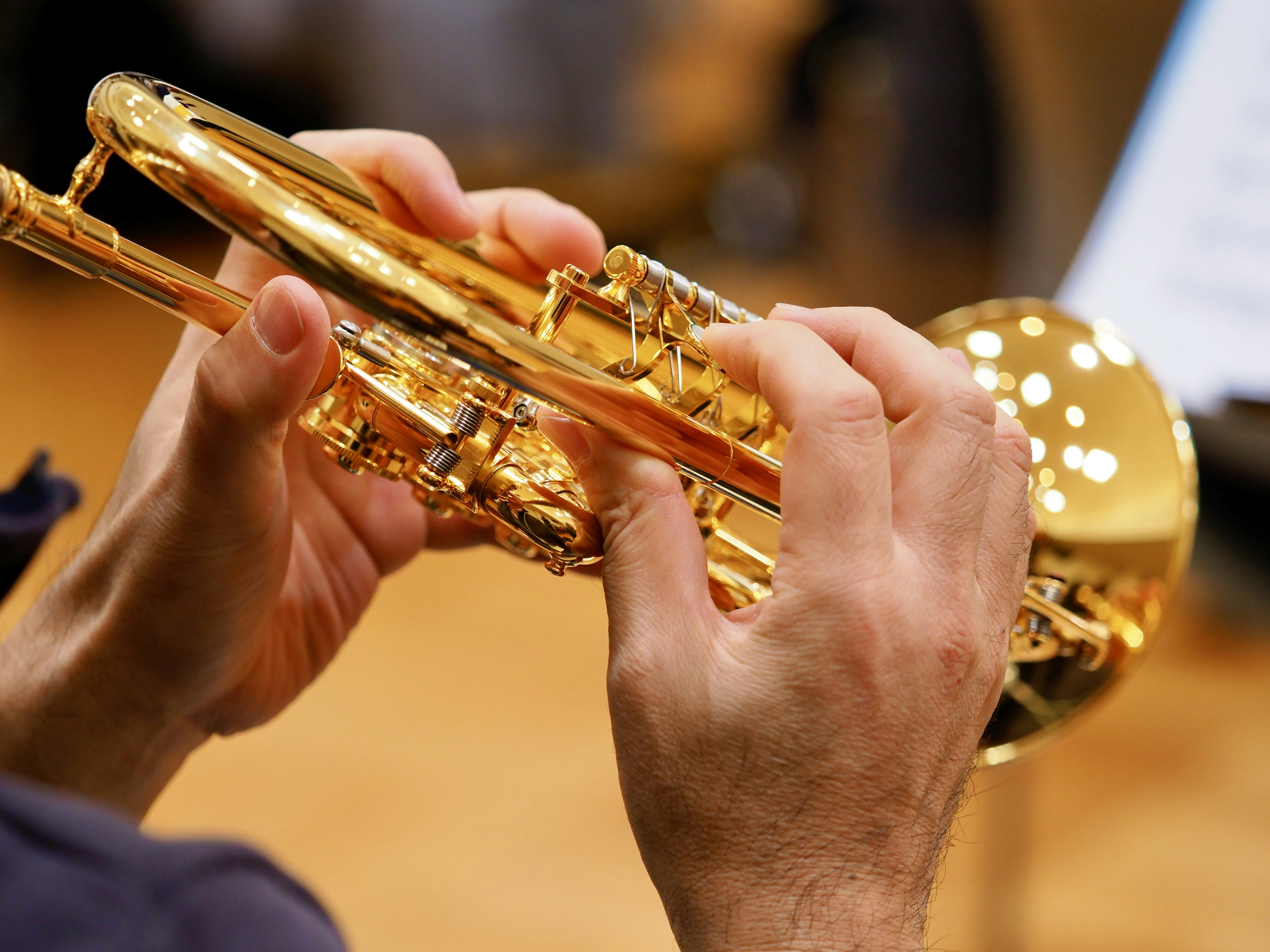 A close up of a person playing a trumpet