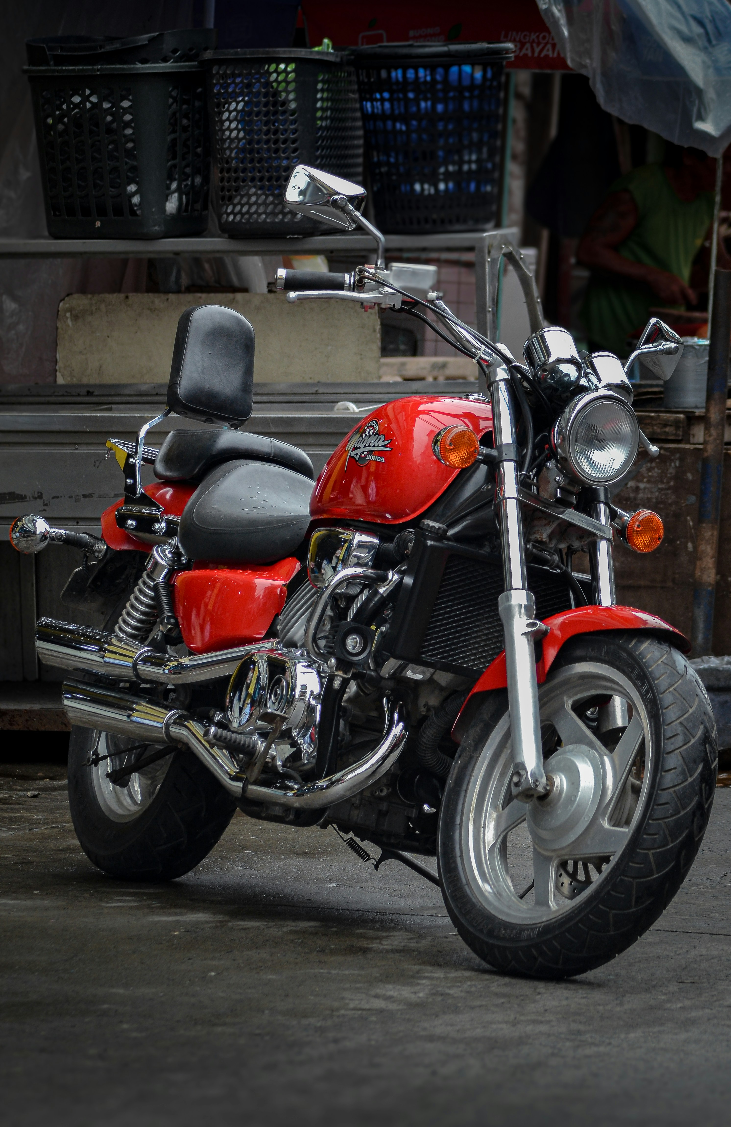 A red motorcycle parked in front of a building