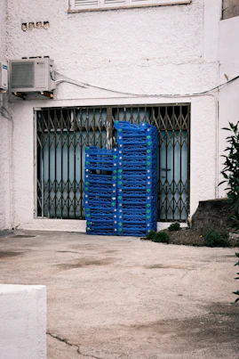 A blue crate sitting in front of a building