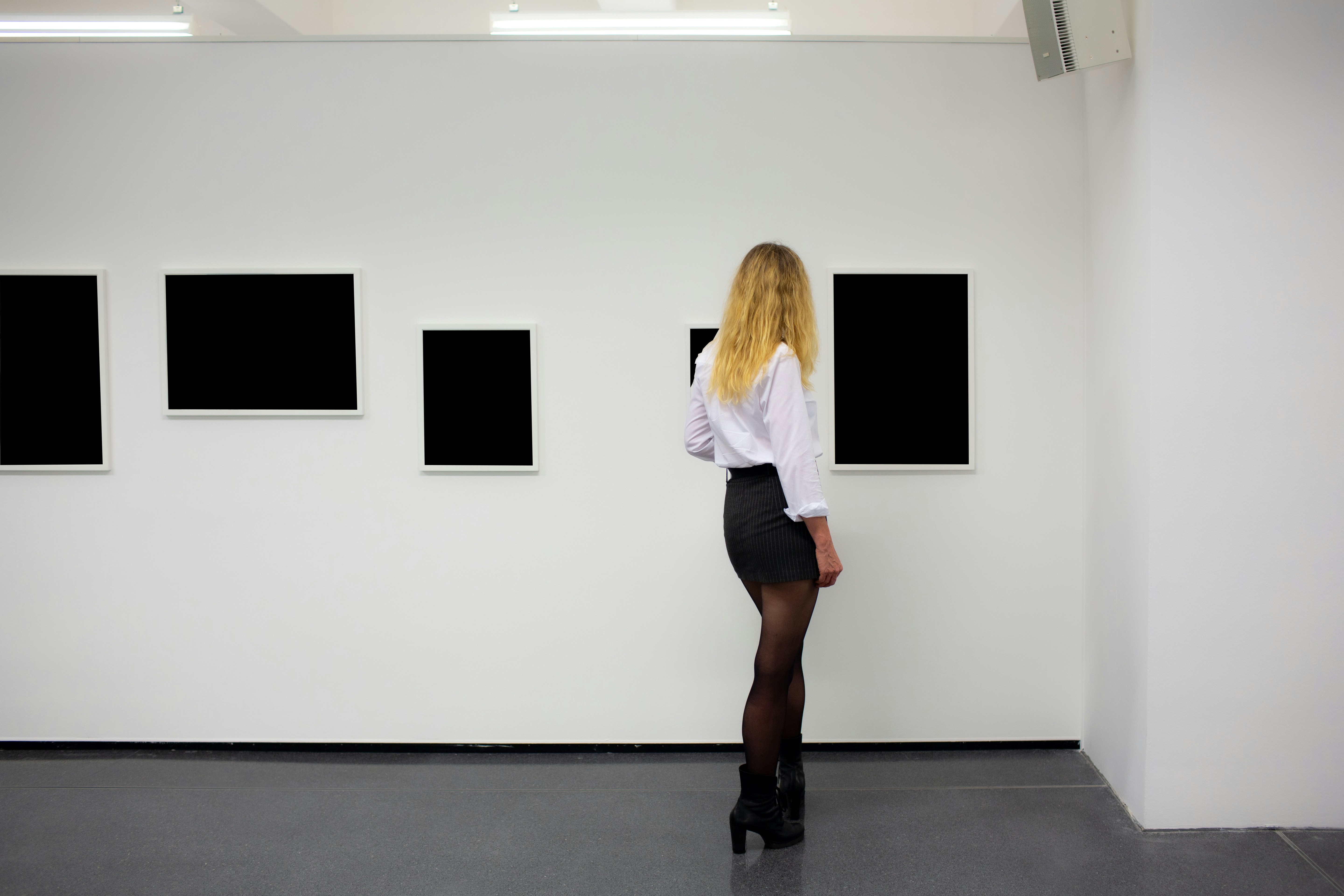 A woman in a white shirt and black skirt, 