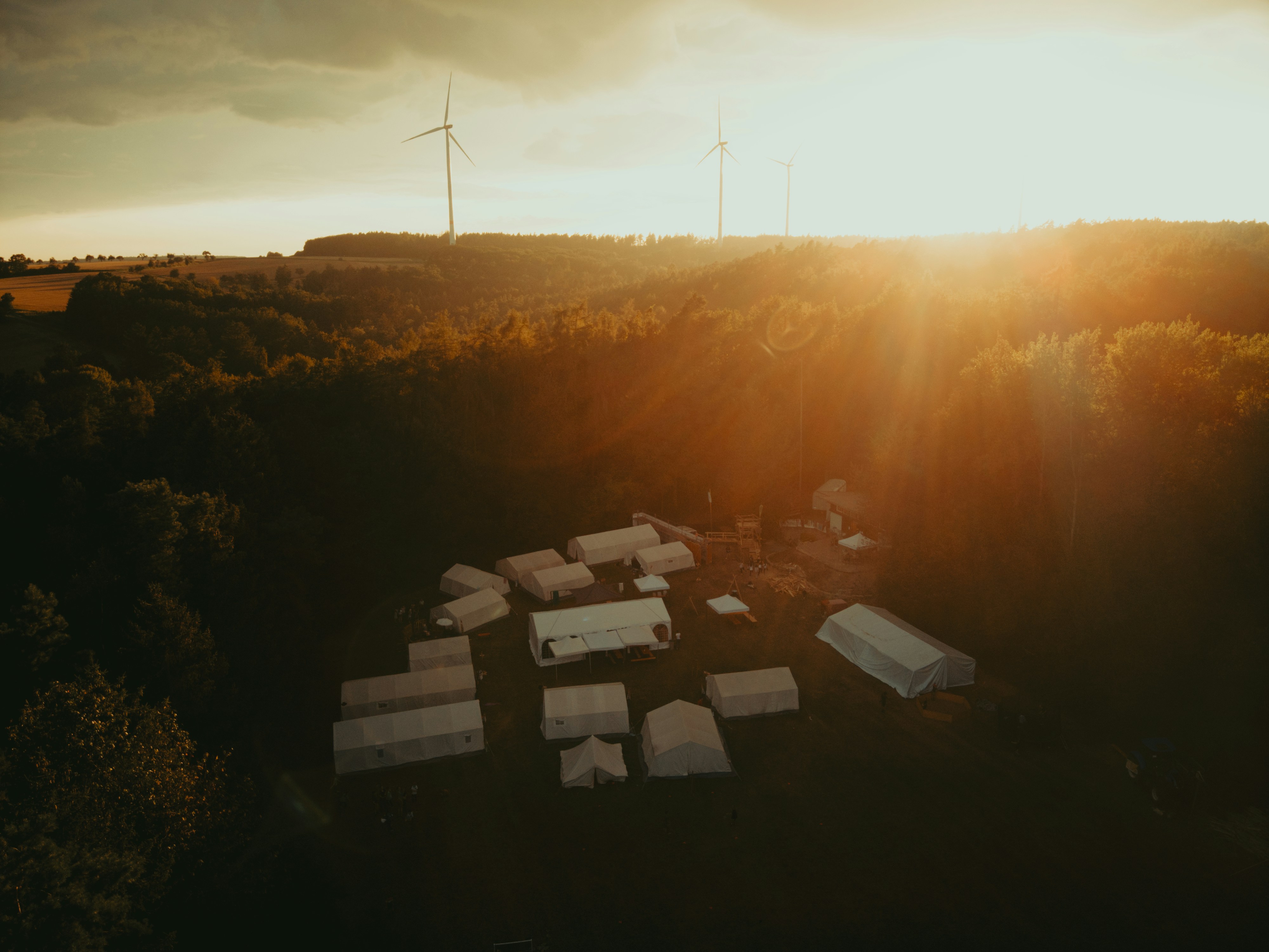 The sun is setting over a field with a lot of boxes