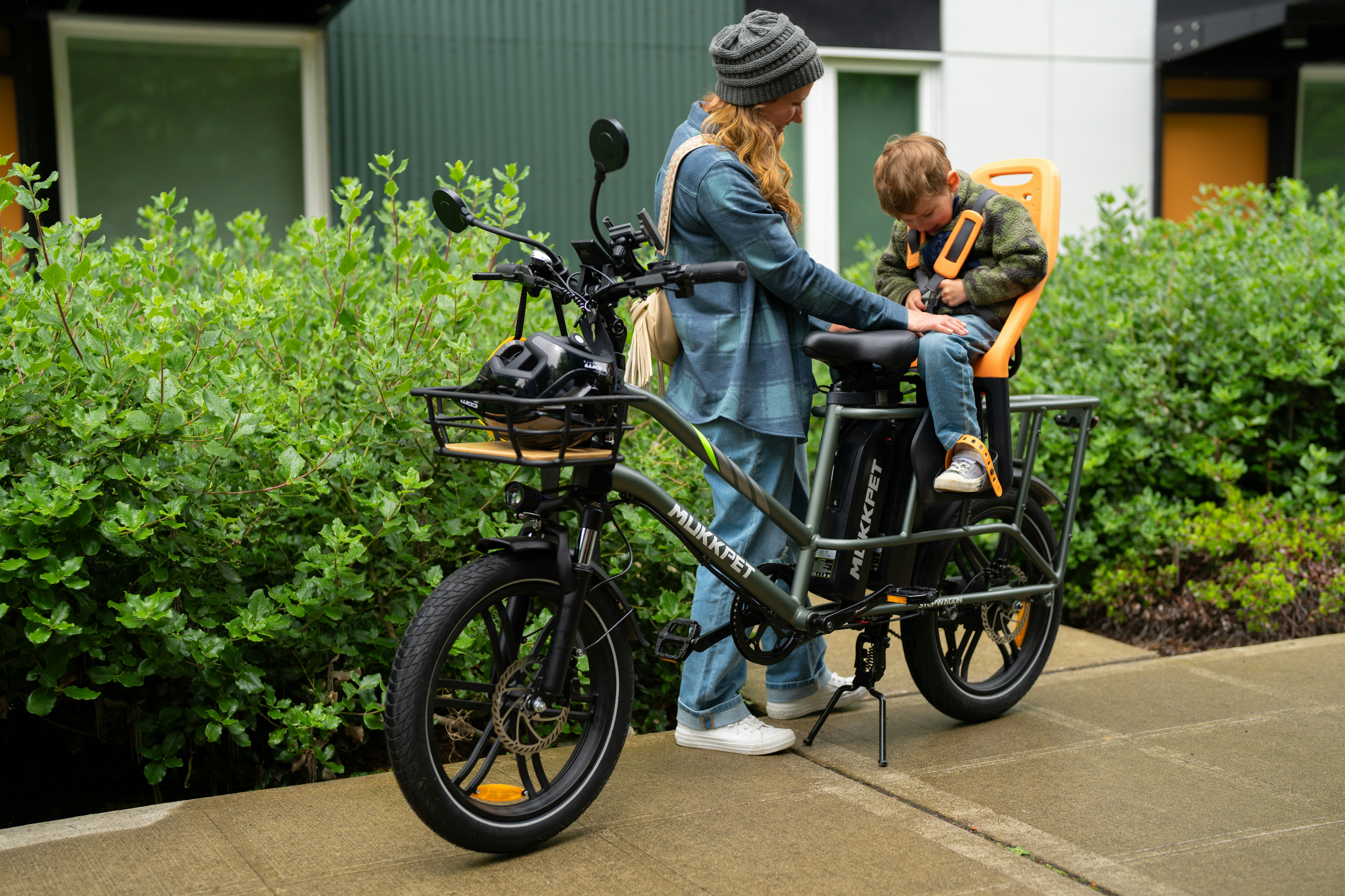 Two people standing next to a parked bike