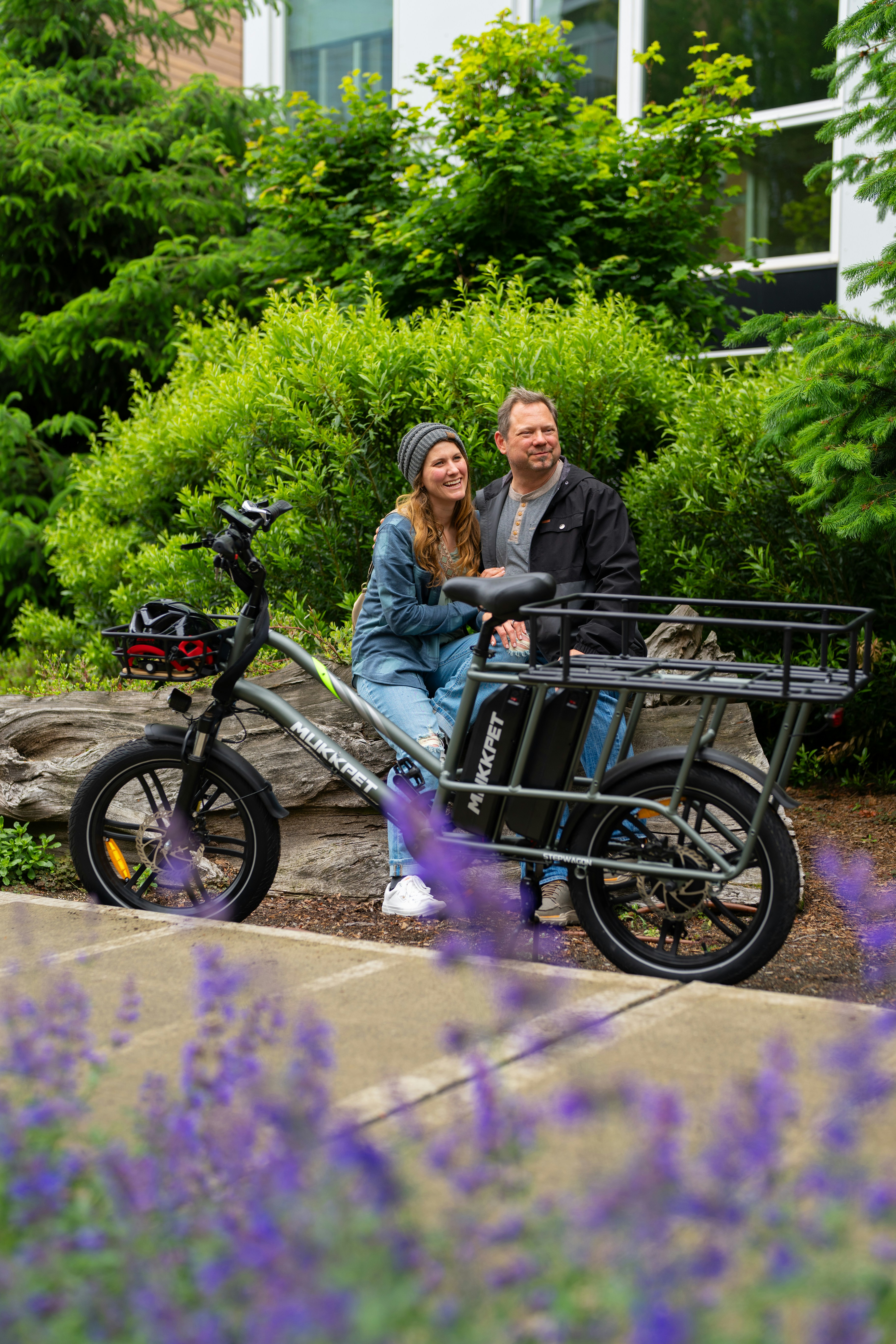 A man and a woman sitting on a bike