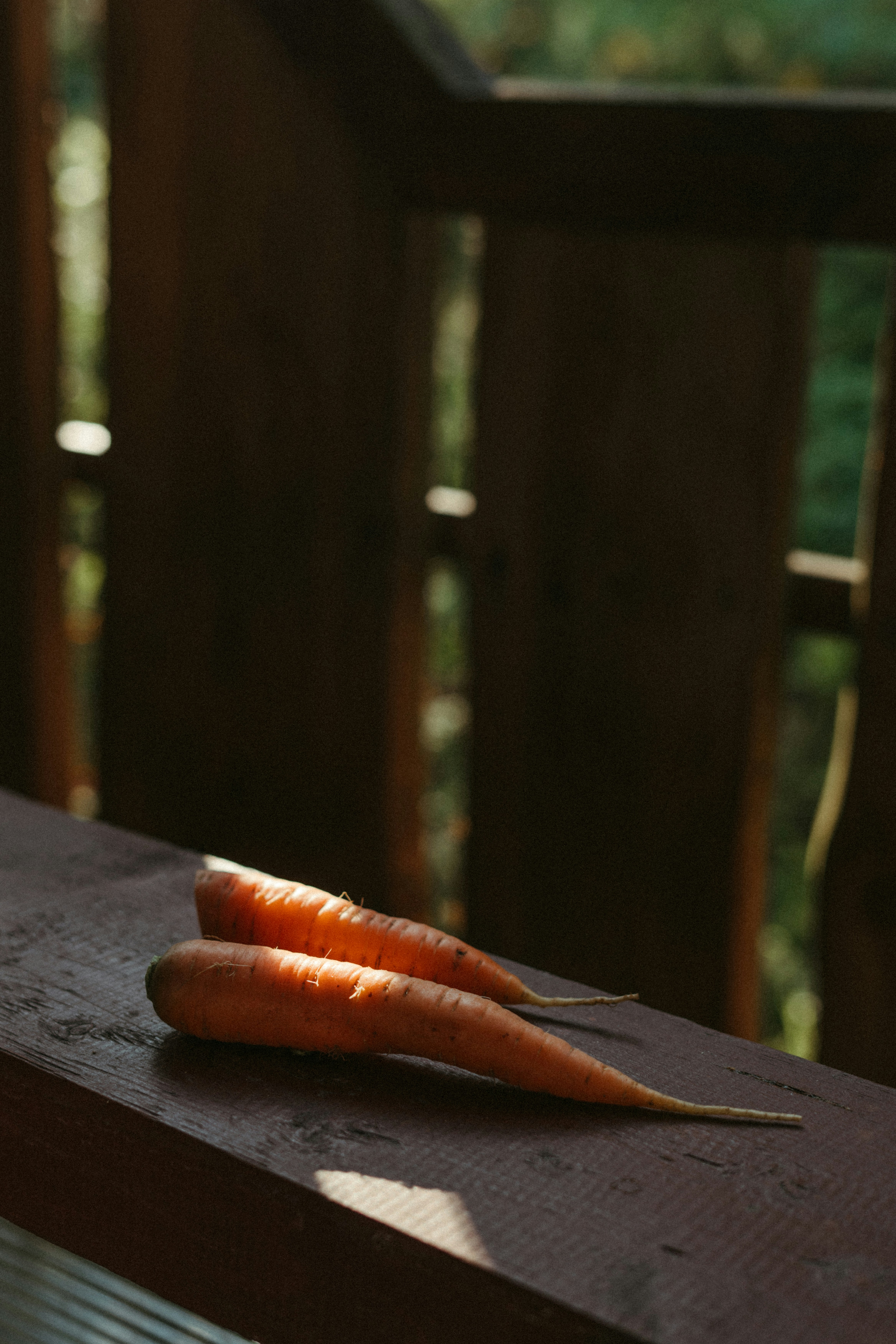 A couple of carrots sitting on top of a wooden table
