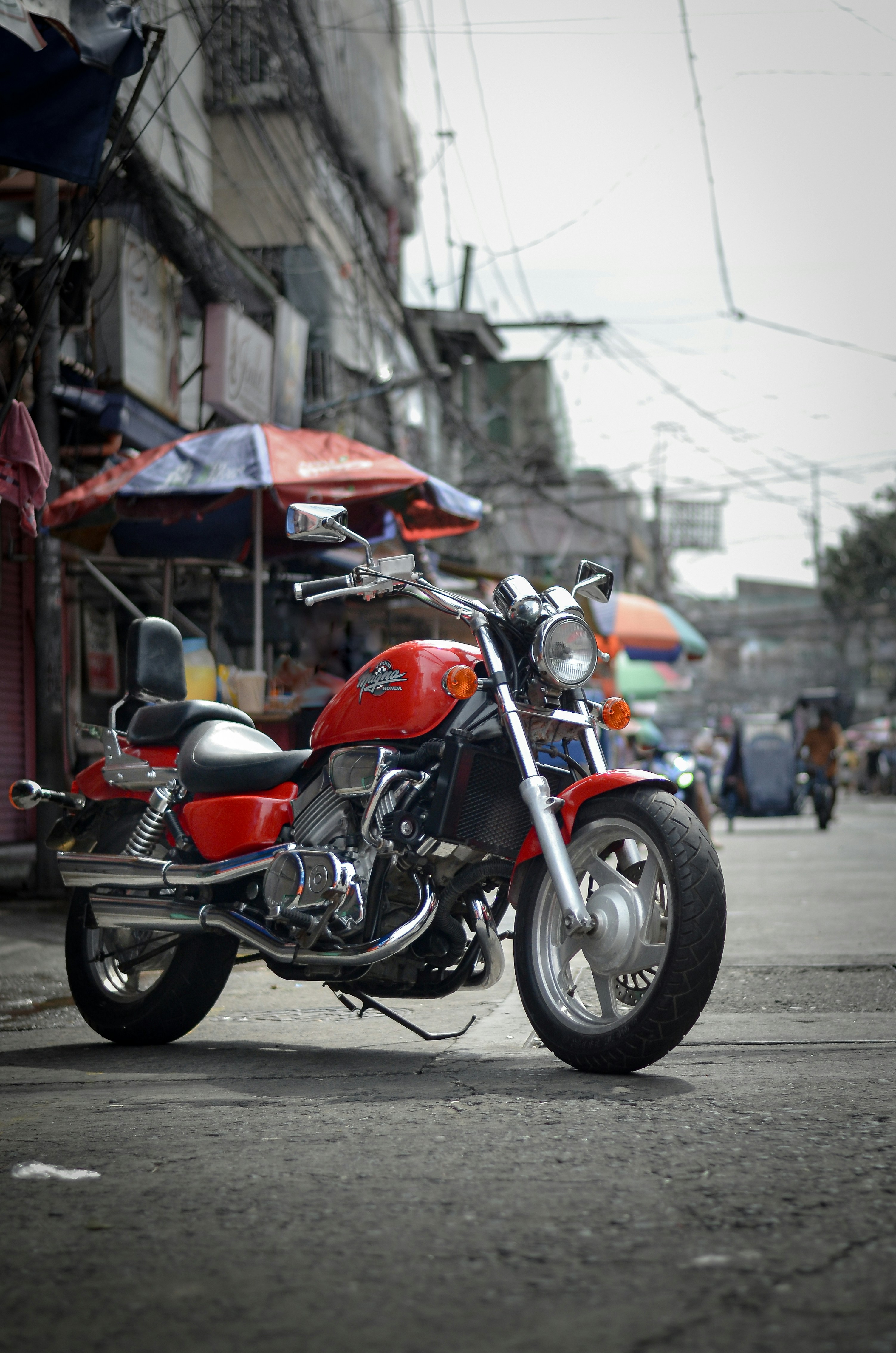 A red motorcycle parked on the side of a road