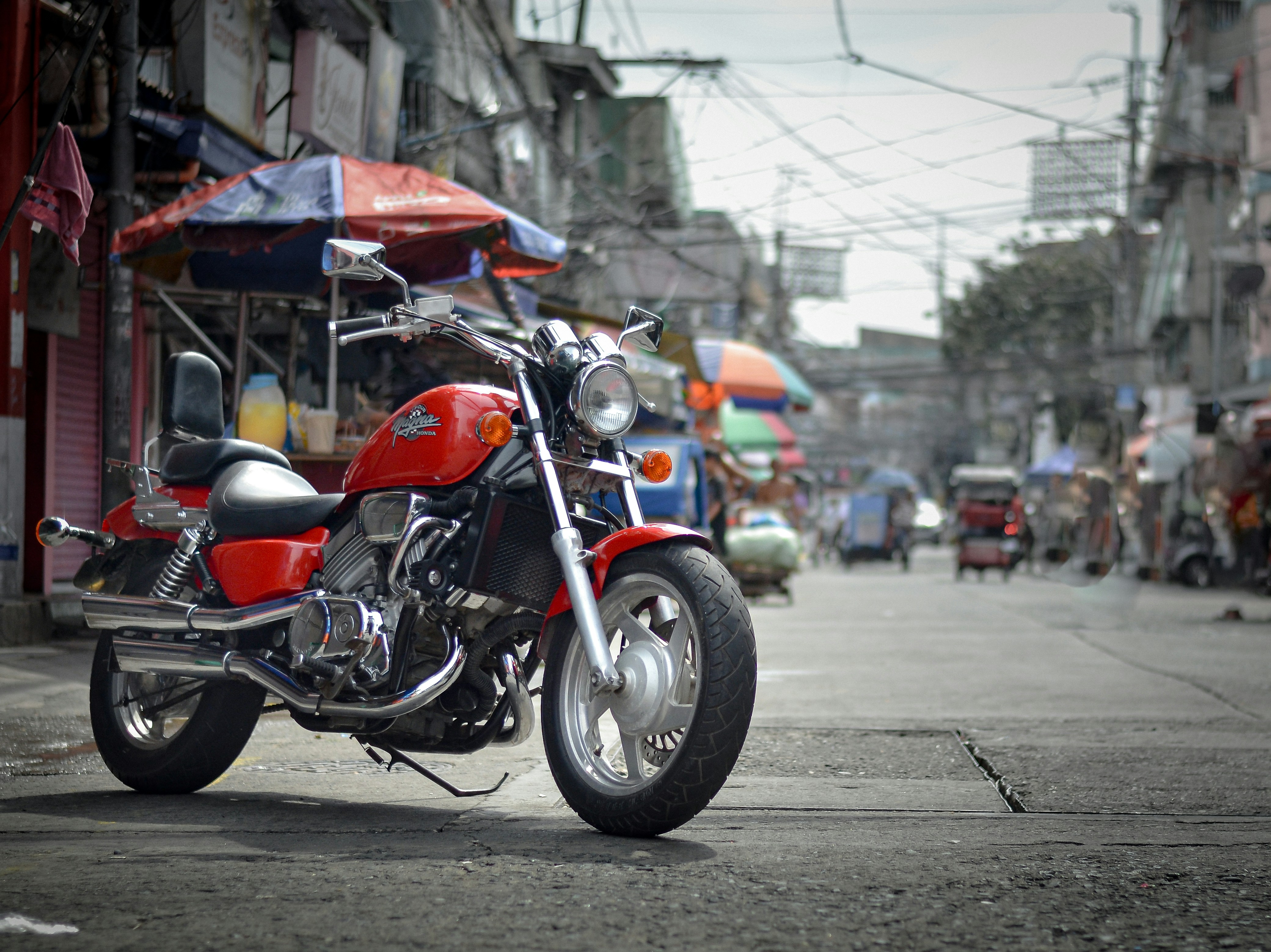 A red motorcycle parked on the side of a road
