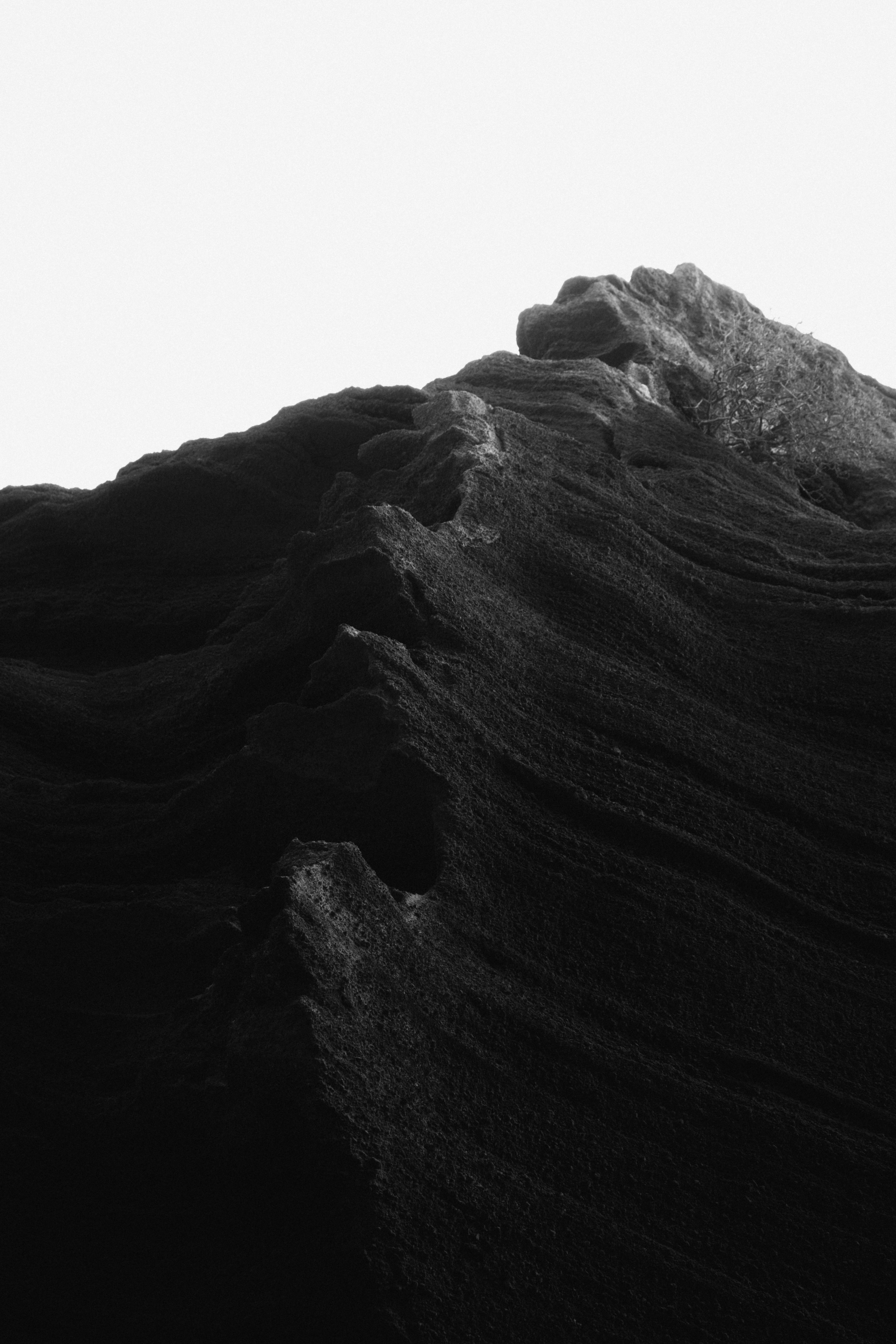 A black and white photo of a person on a surfboard