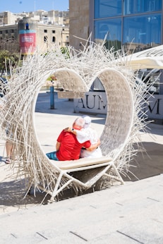 A couple of people that are sitting on a bench