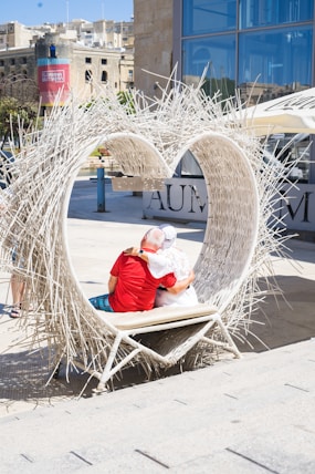 A couple of people that are sitting on a bench