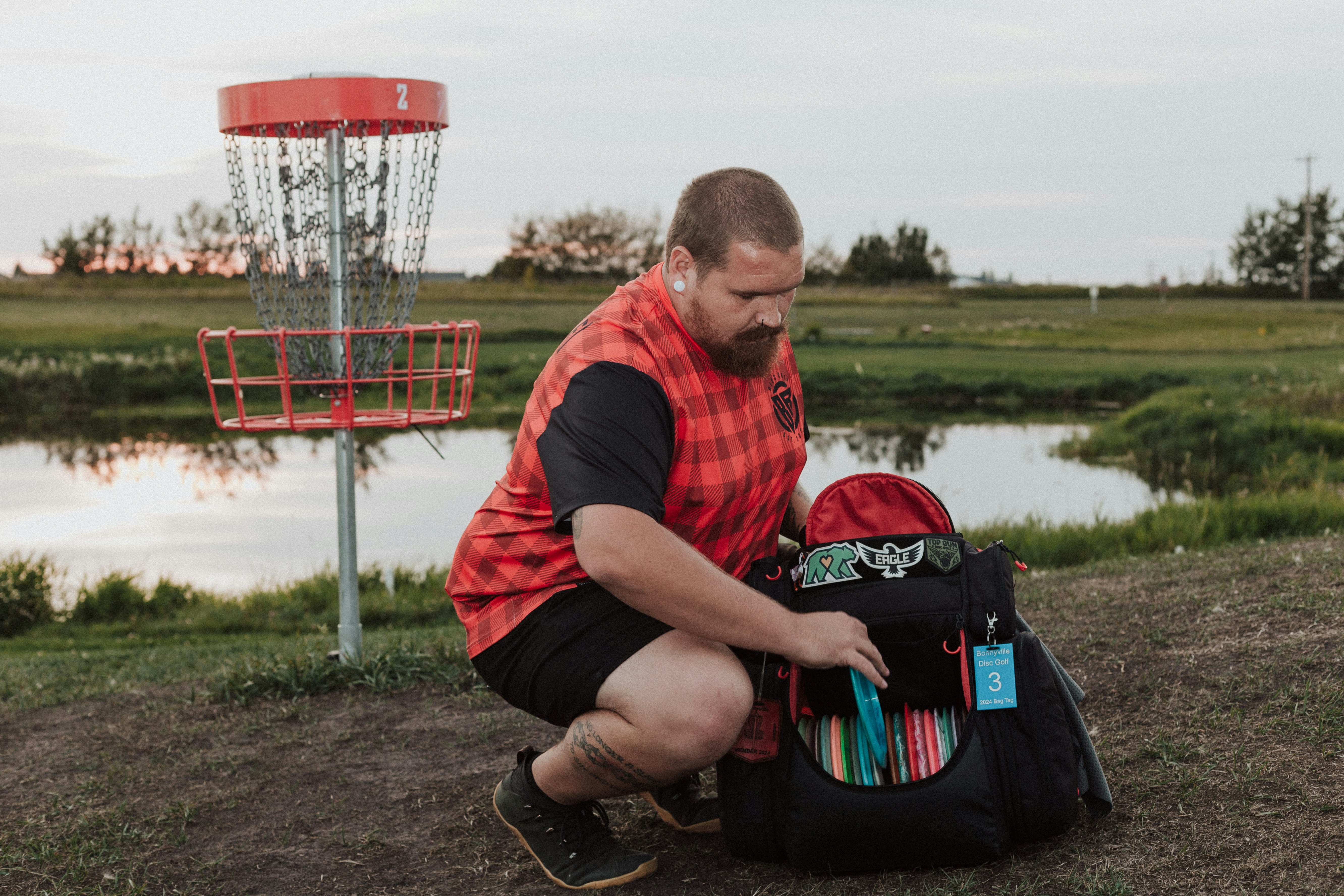 A man sitting on the ground next to a frisbee