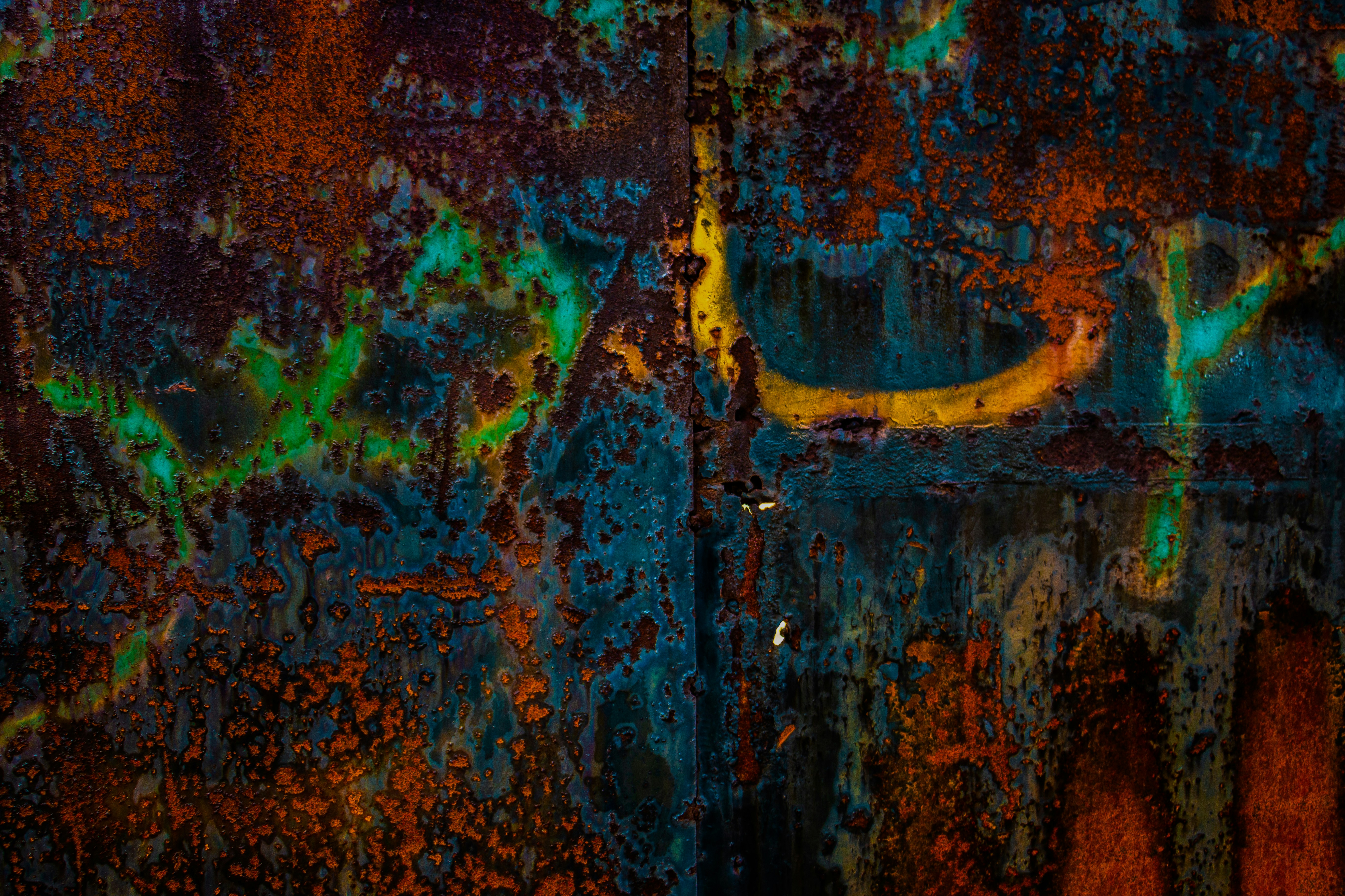 A close up of a metal door with paint splattered on it, 