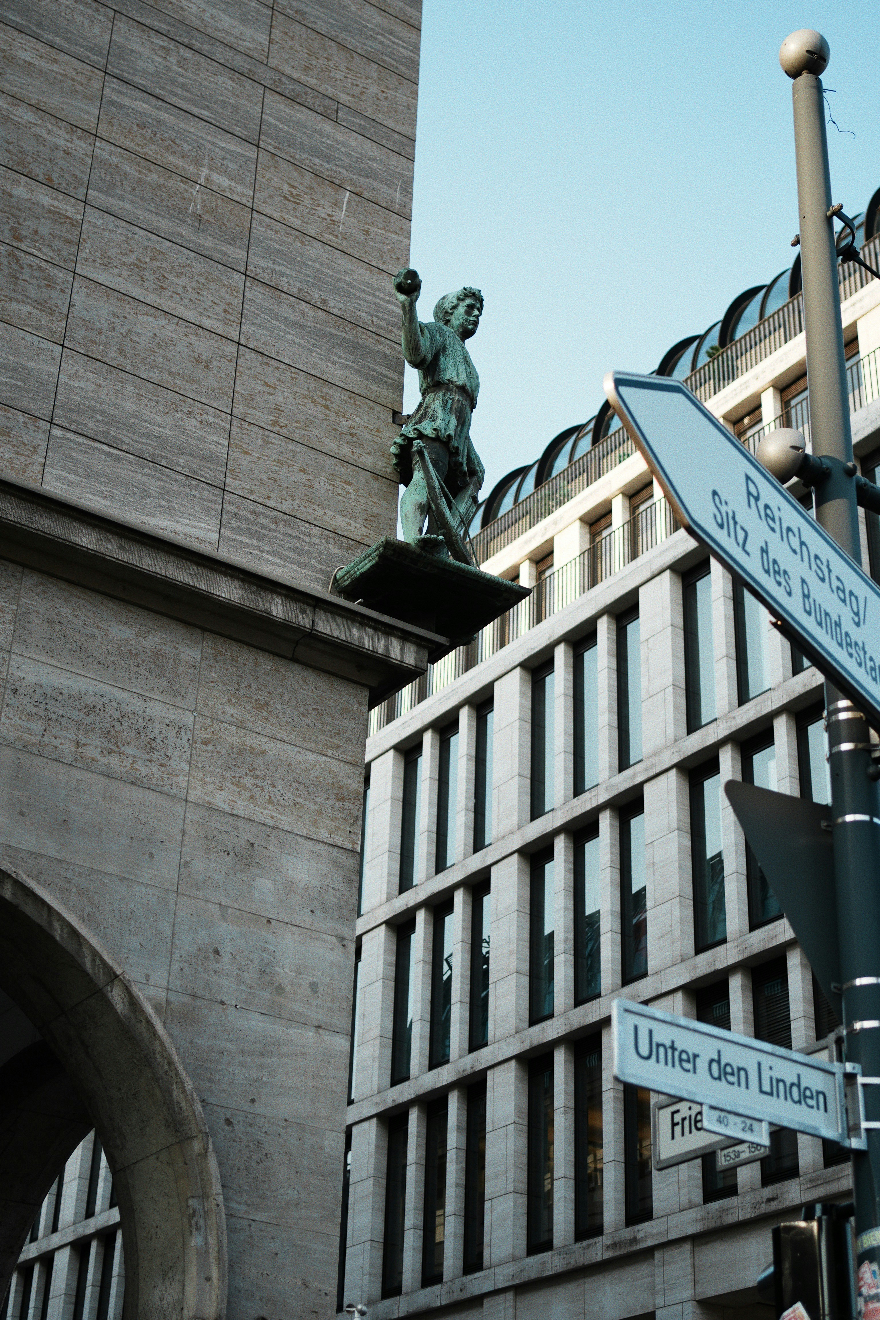 A street sign in front of a tall building