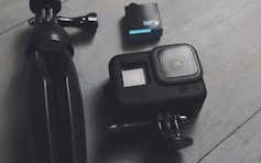 A couple of cameras sitting on top of a wooden floor