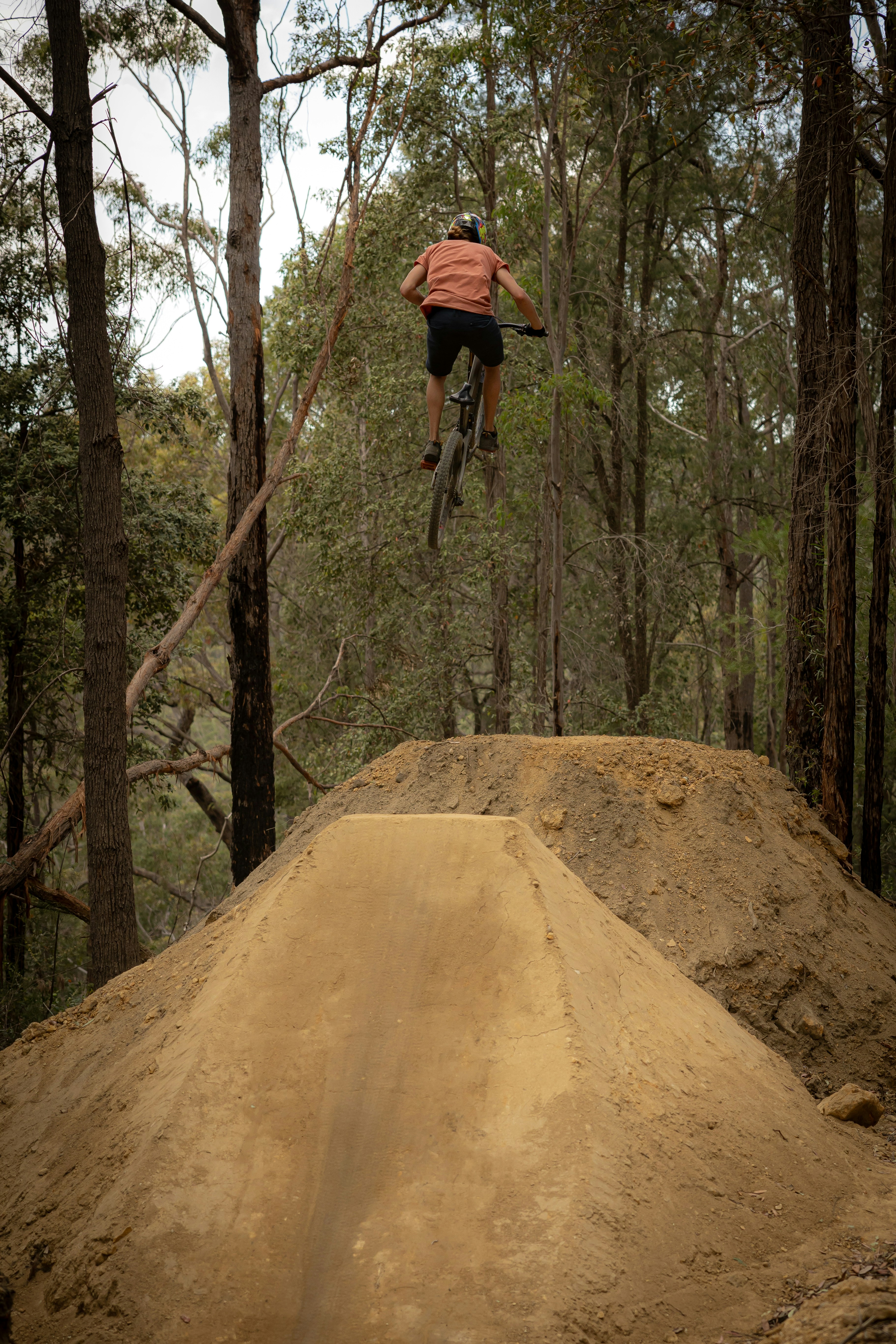 A man flying through the air while riding a bike