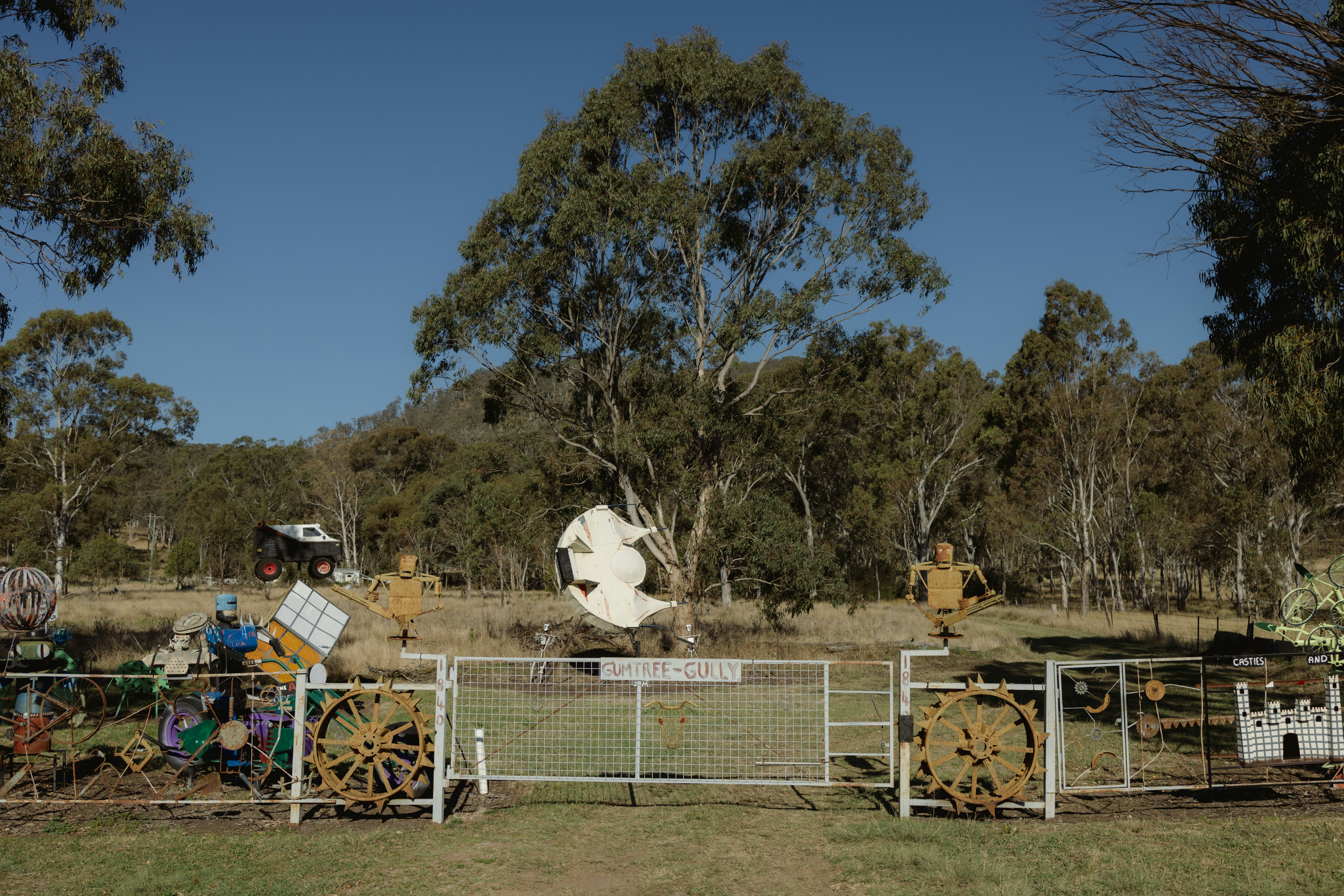 A fenced in area with a large white cow in the background