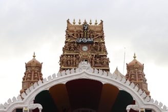 A large white and gold building with a clock tower