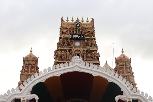A large white and gold building with a clock tower