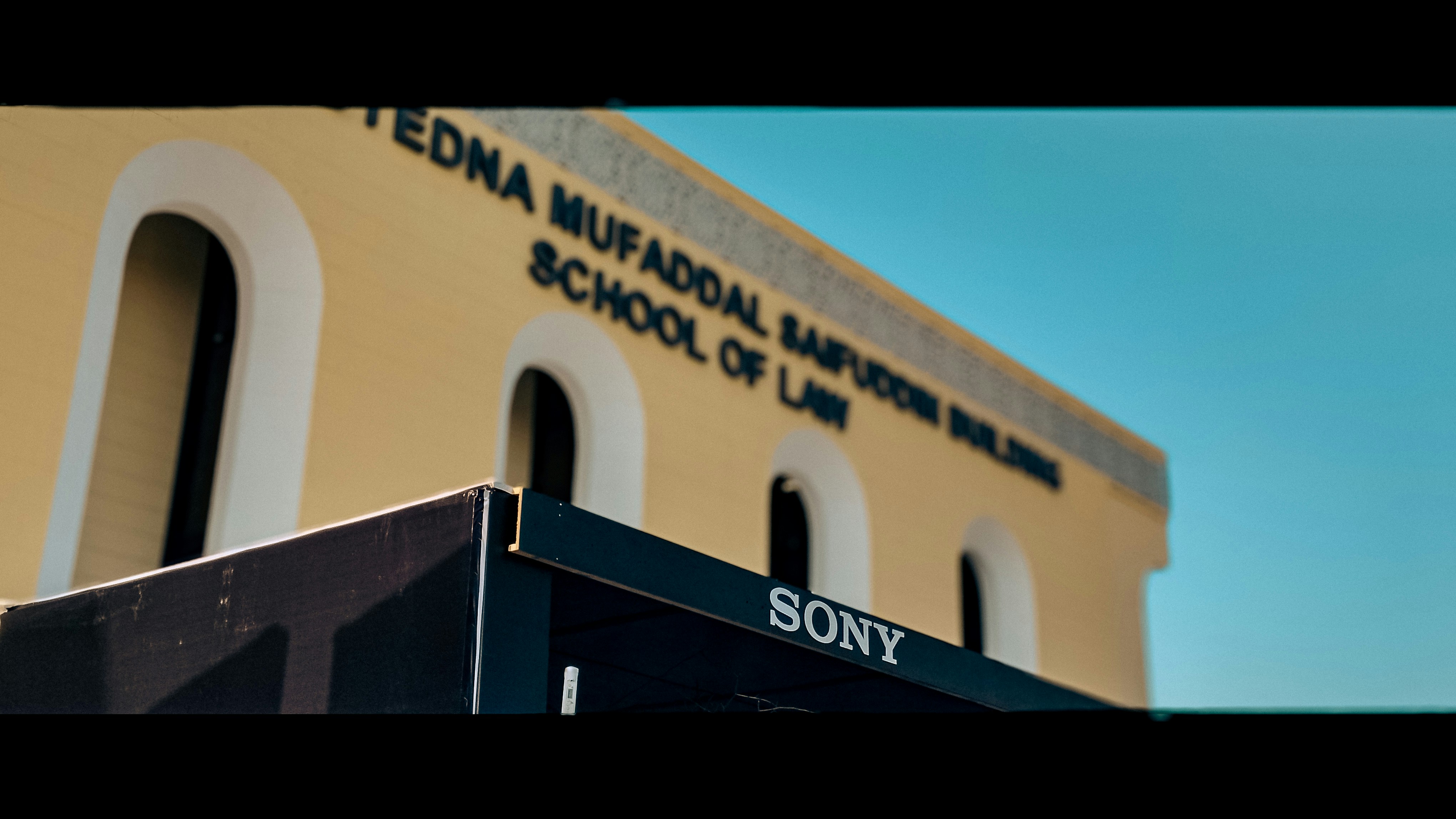 The front of a school building with a blue sky in the background