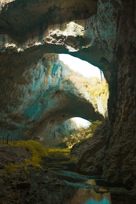 A cave filled with lots of rocks and water