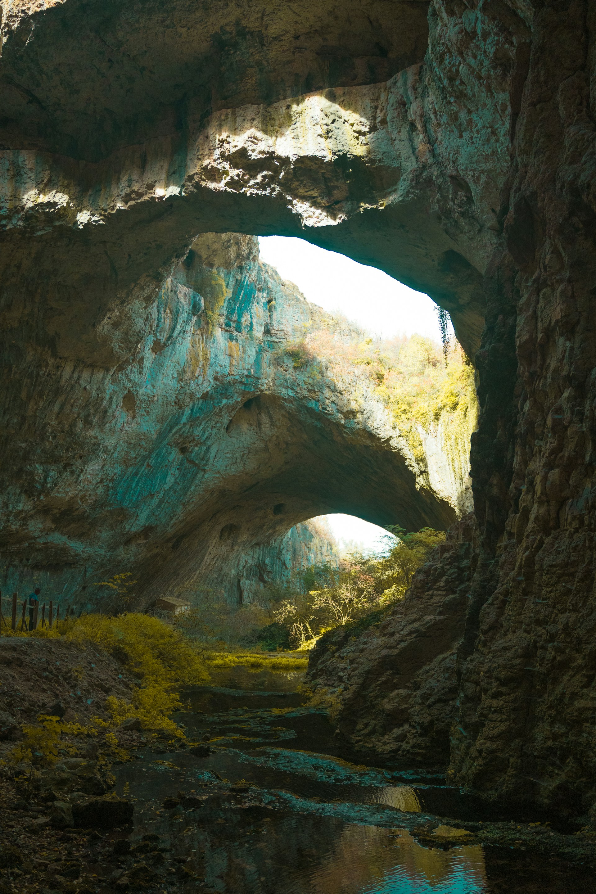 A cave filled with lots of rocks and water