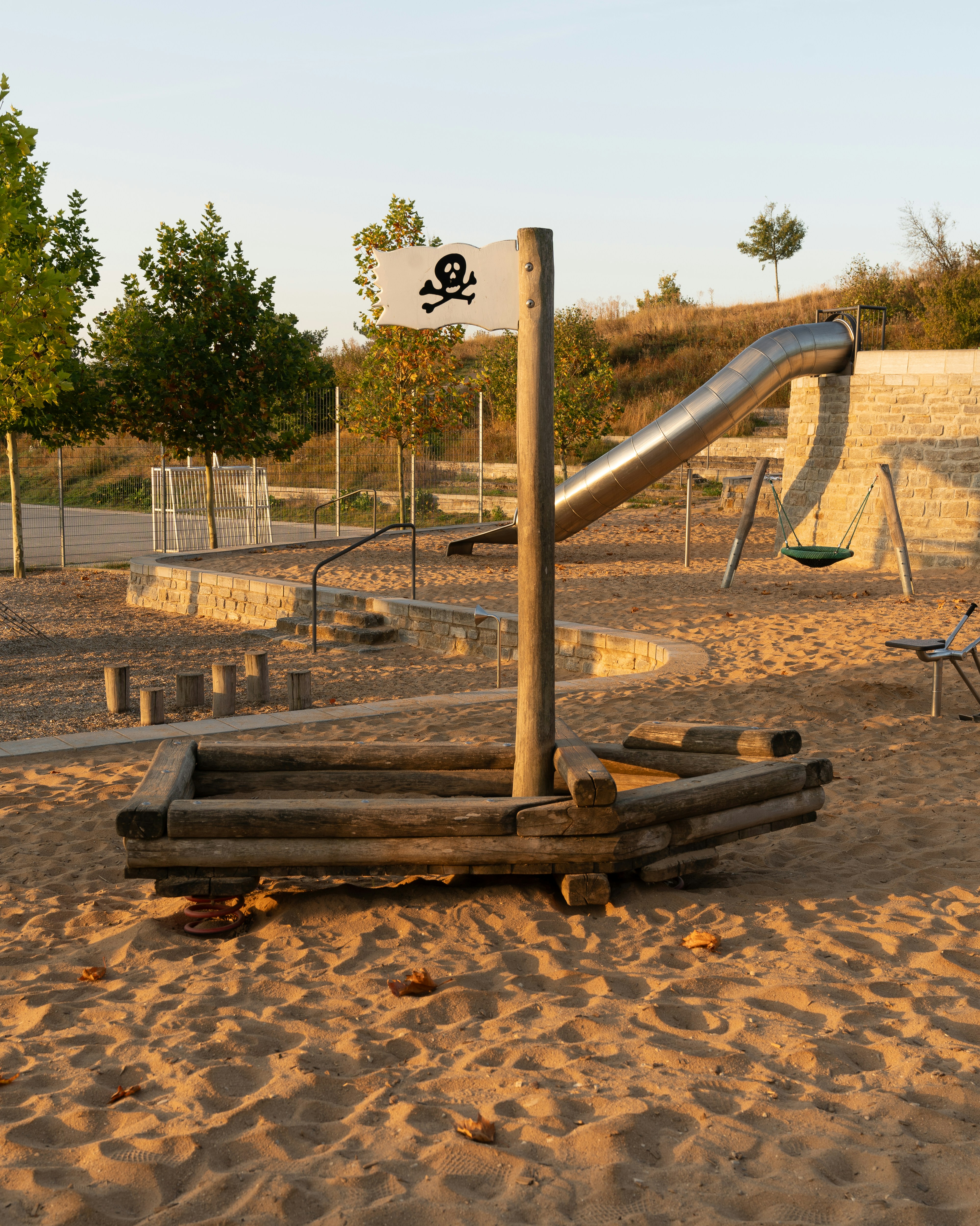 A playground with a slide in the sand