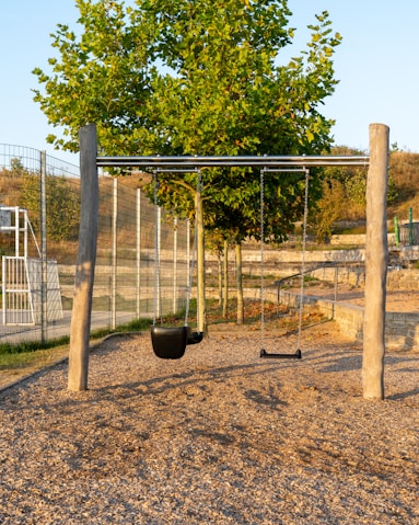 A playground with swings and a swing set