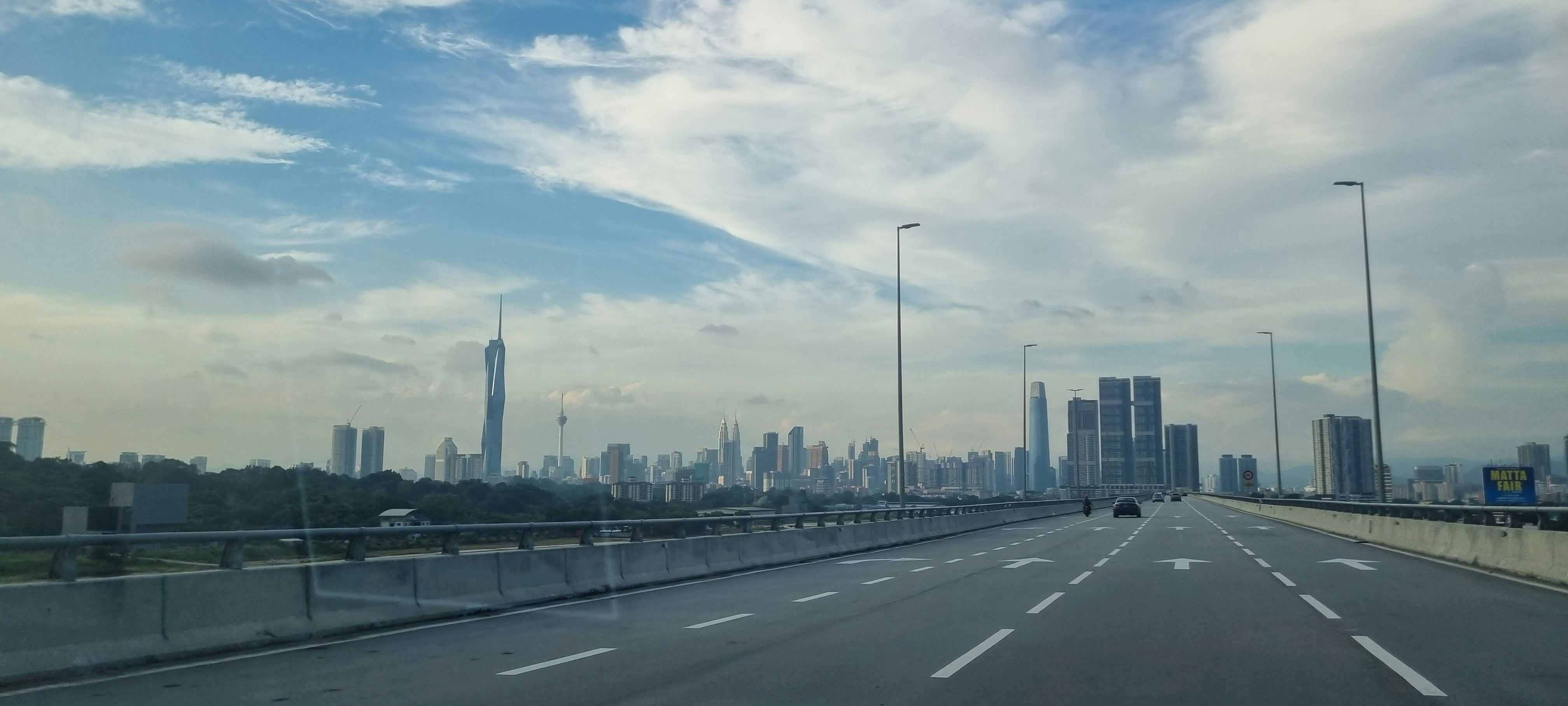 A view of a highway with a city in the background