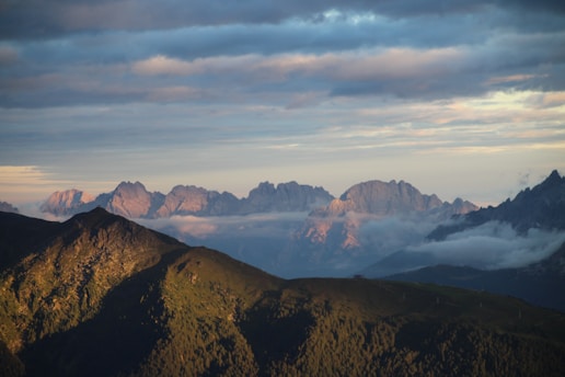 A view of a mountain range with low lying clouds