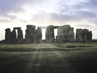 A group of stonehenge standing in a field