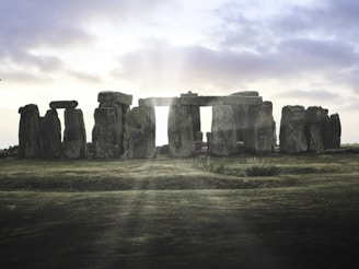 A group of stonehenge standing in a field