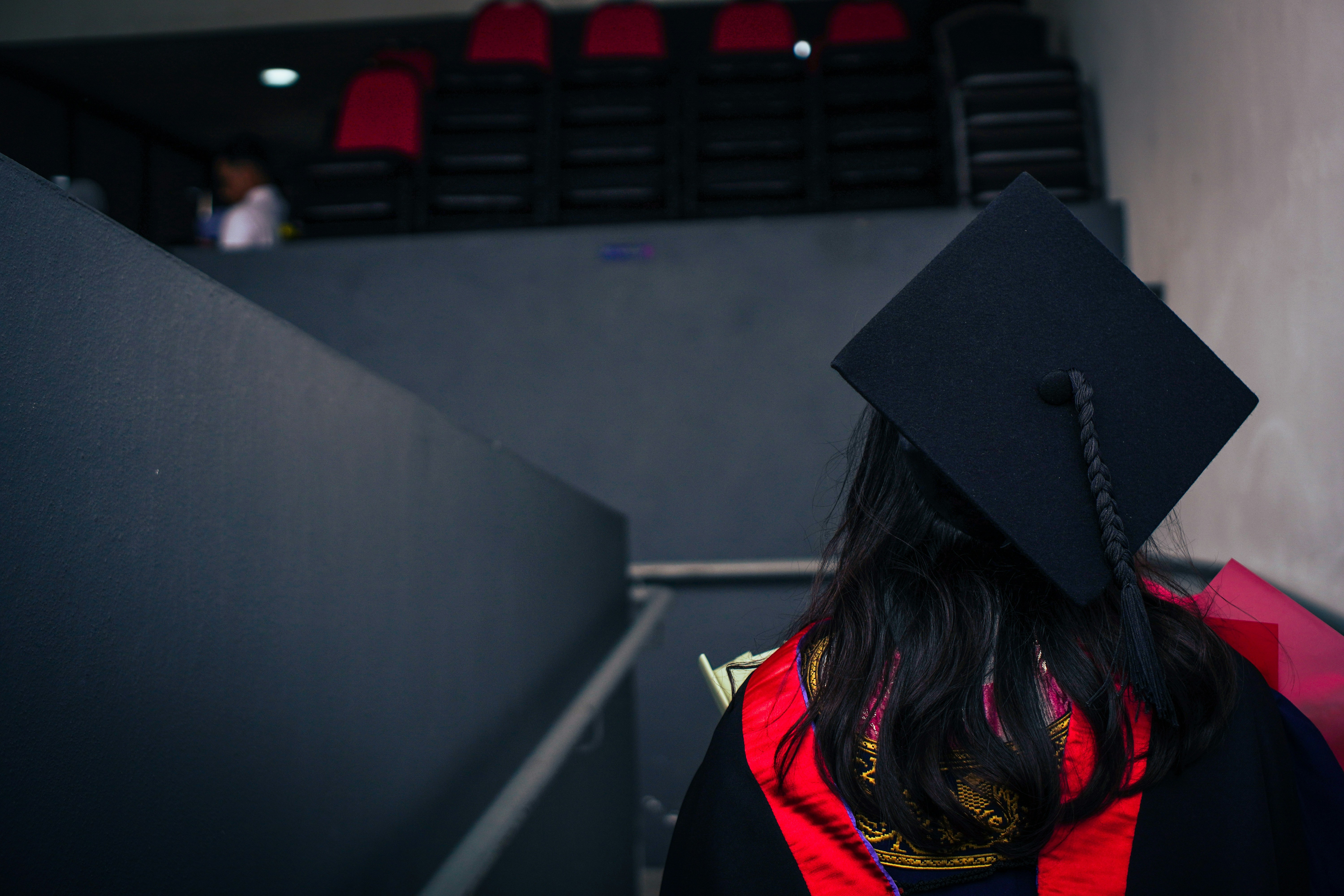 A woman wearing a graduation cap and gown