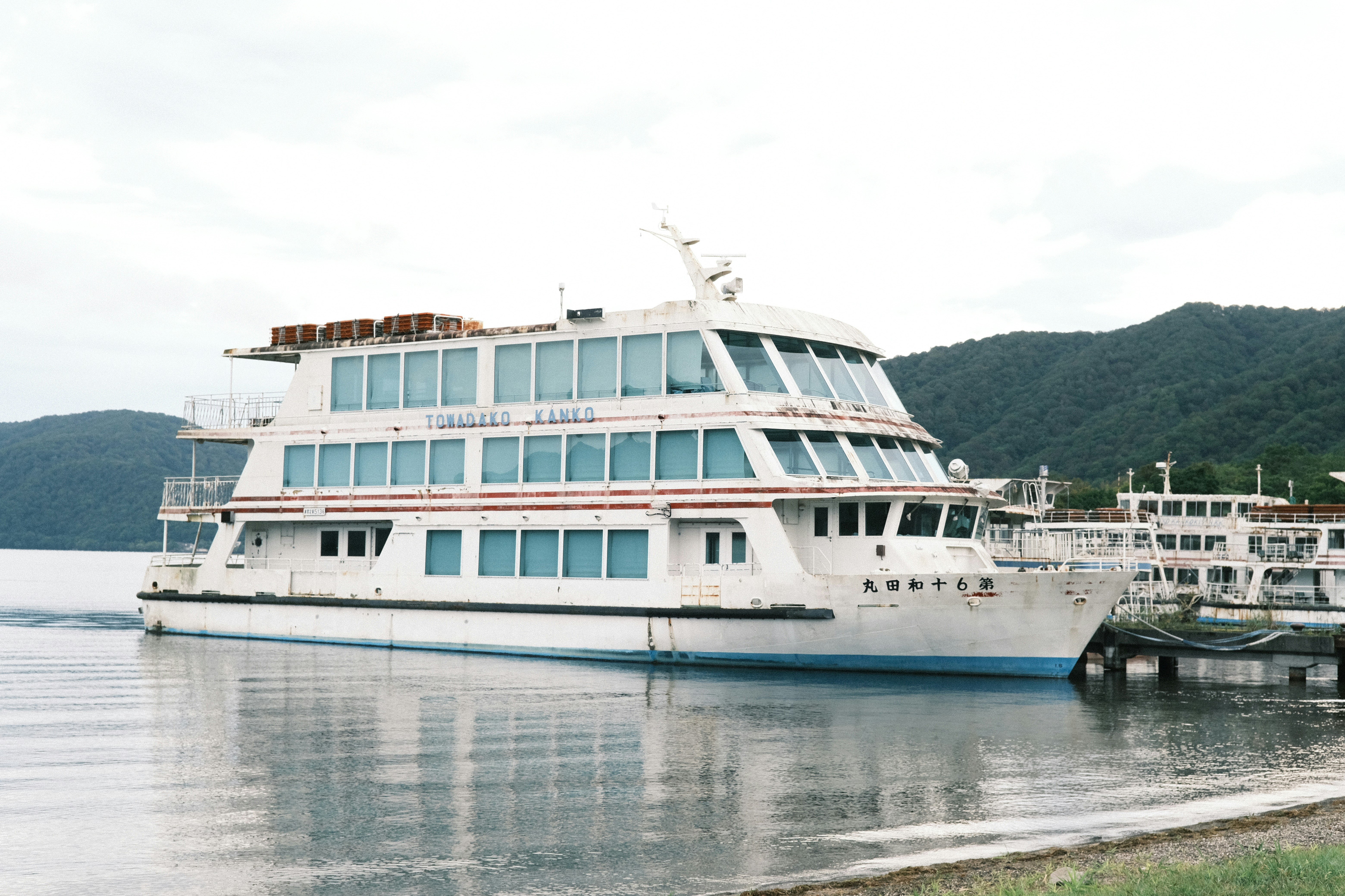 A large boat floating on top of a body of water