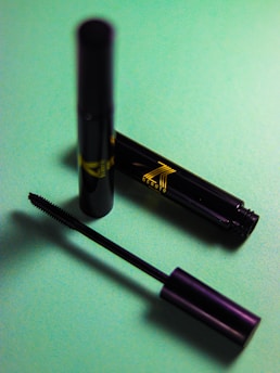 A mascara and a mascara tube sitting on a table