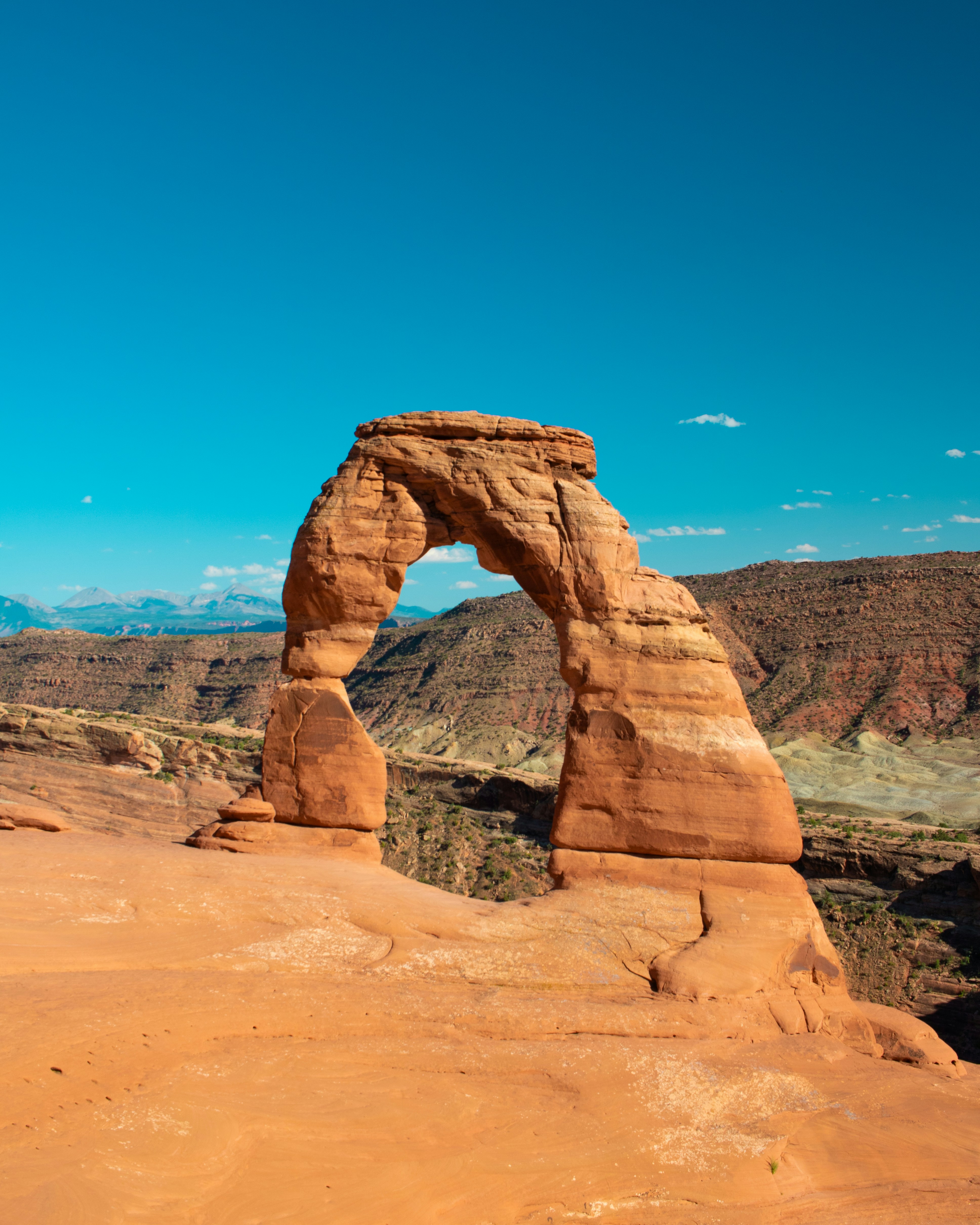 Delicate Arch, a natural sandstone formation in Arches National Park, Utah, stands at 52 feet (16 meters) tall, making it one of the park's most iconic landmarks. Formed over millions of years by erosion, it is composed of Entrada Sandstone. It’s a free-standing arch and a symbol of Utah, recognized worldwide. The light opening beneath the arch is 46 feet high and 32 feet wide, the largest free-standing arch in the park. The term \